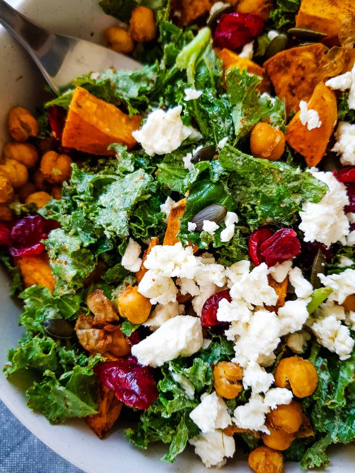 Close up of kale, chickpeas and sweet potato salad with feta cheese.