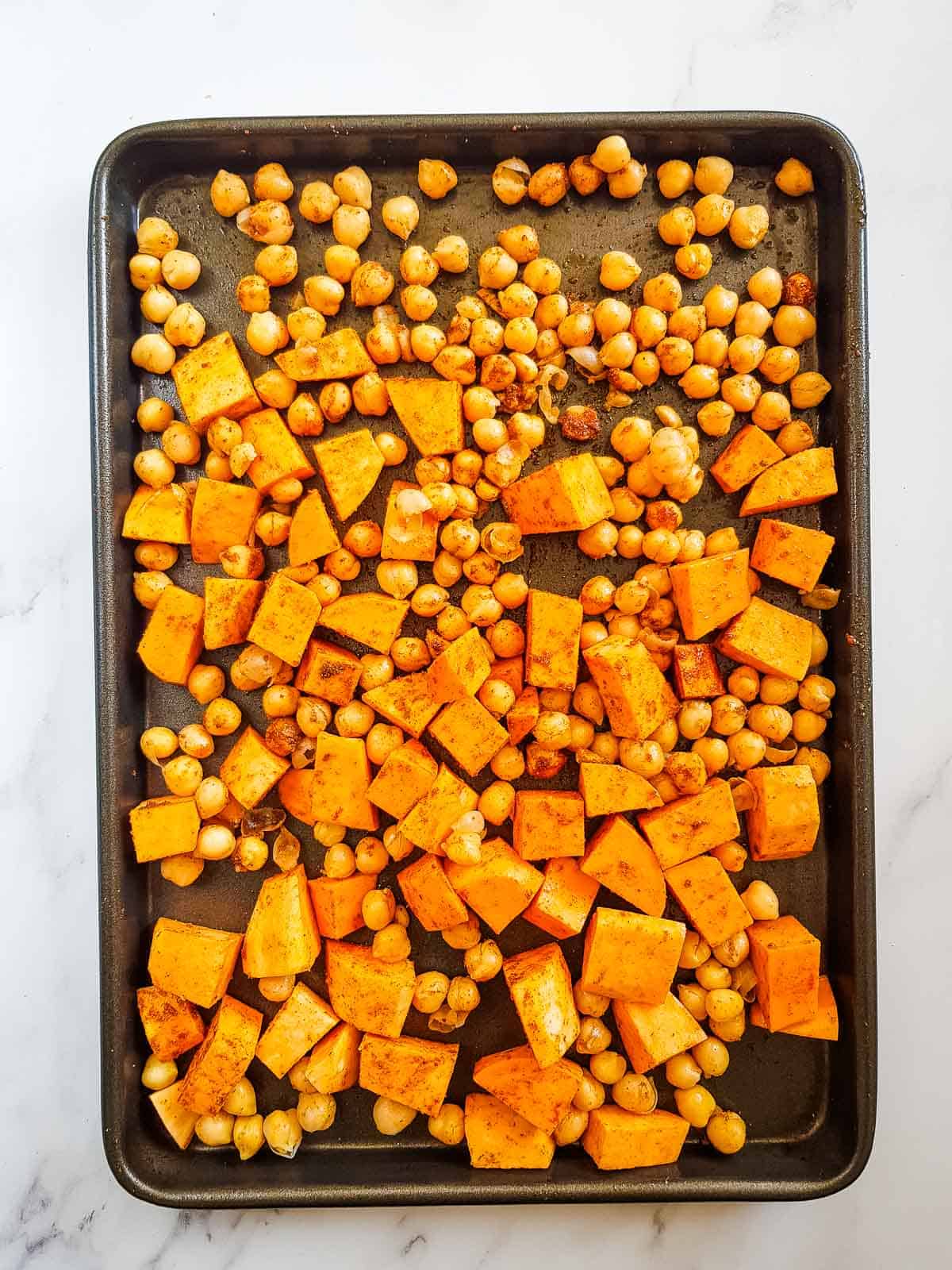 Sweet potatoes and chickpeas on a sheet pan.