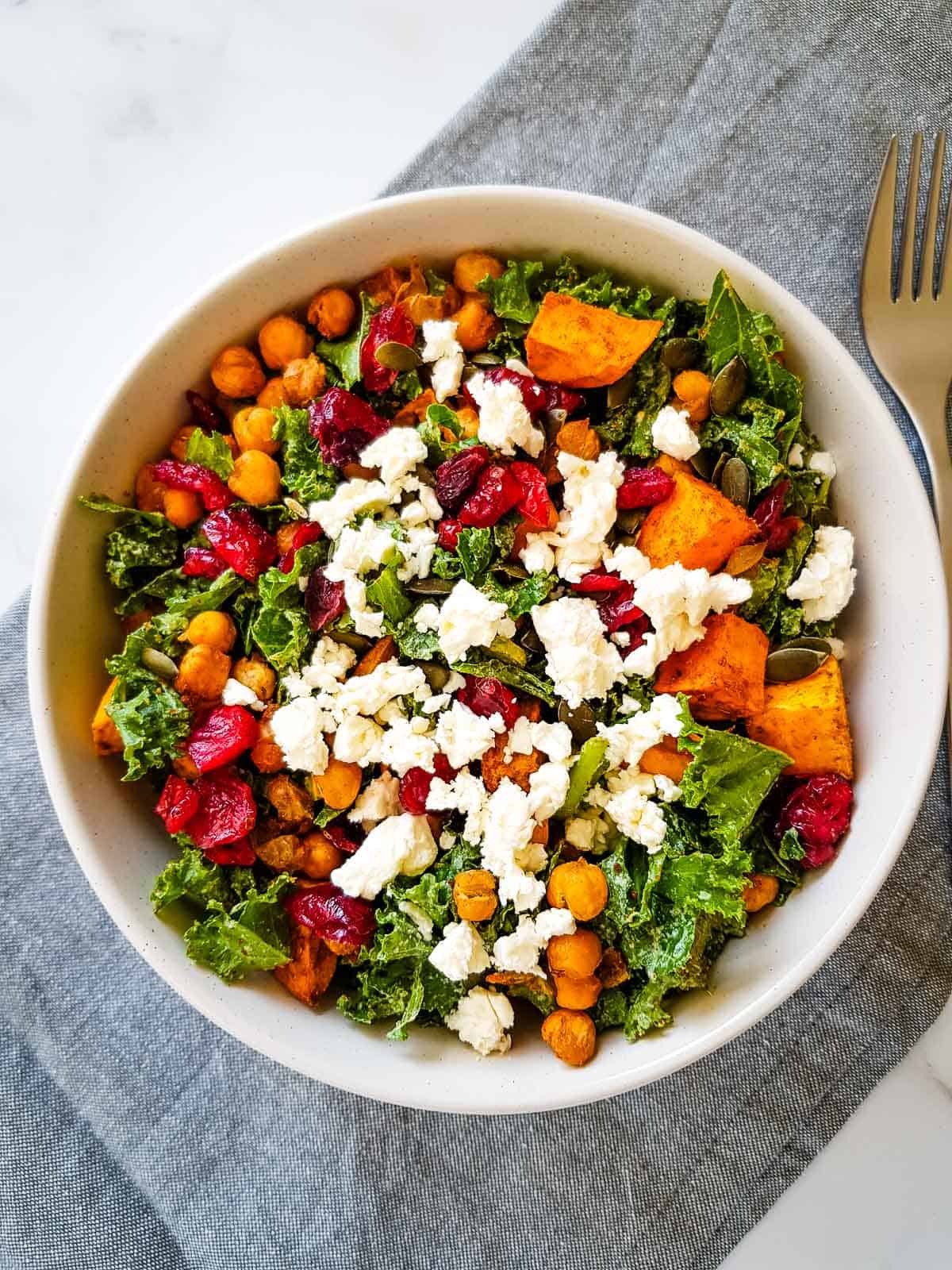 Kale and sweet potato salad with feta cheese and cranberries.