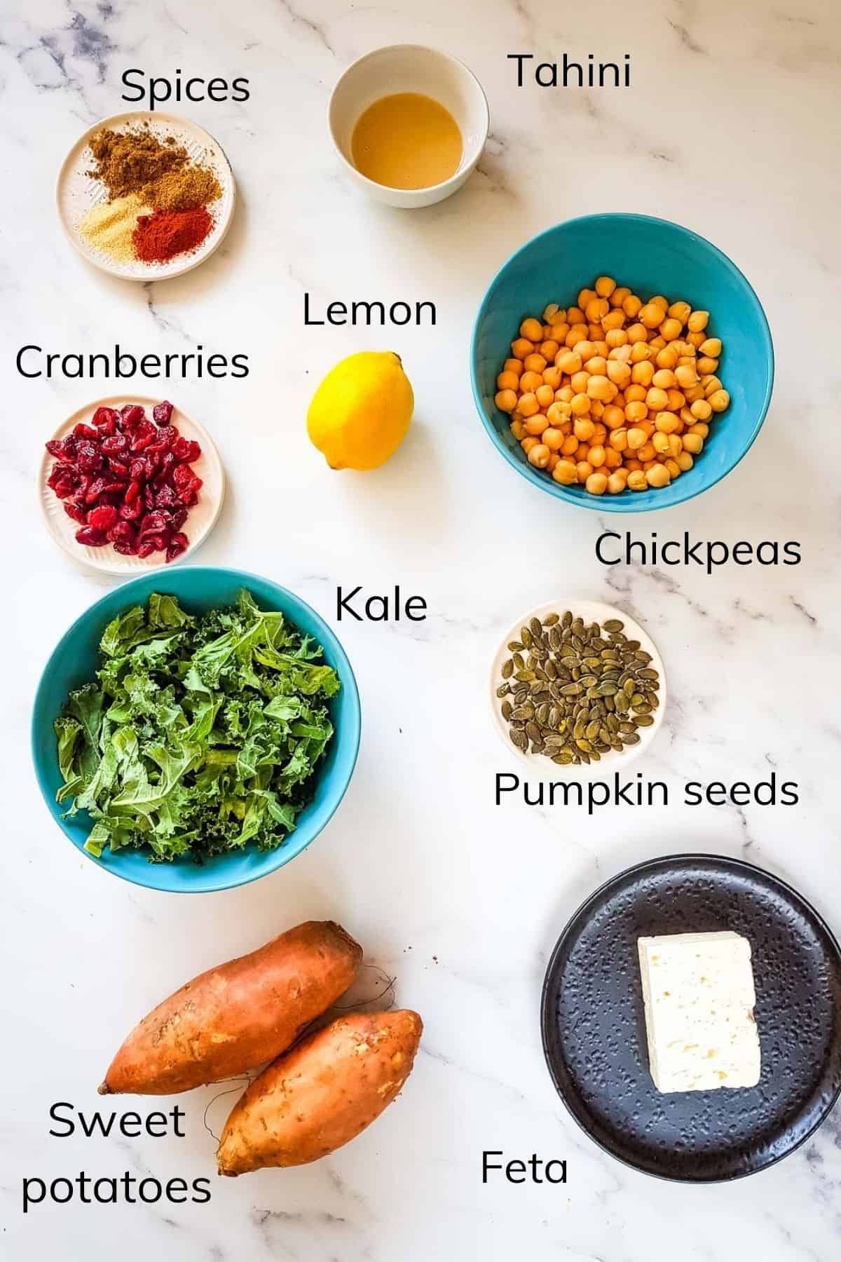 Ingredients for kale and sweet potato salad laid out on a table.