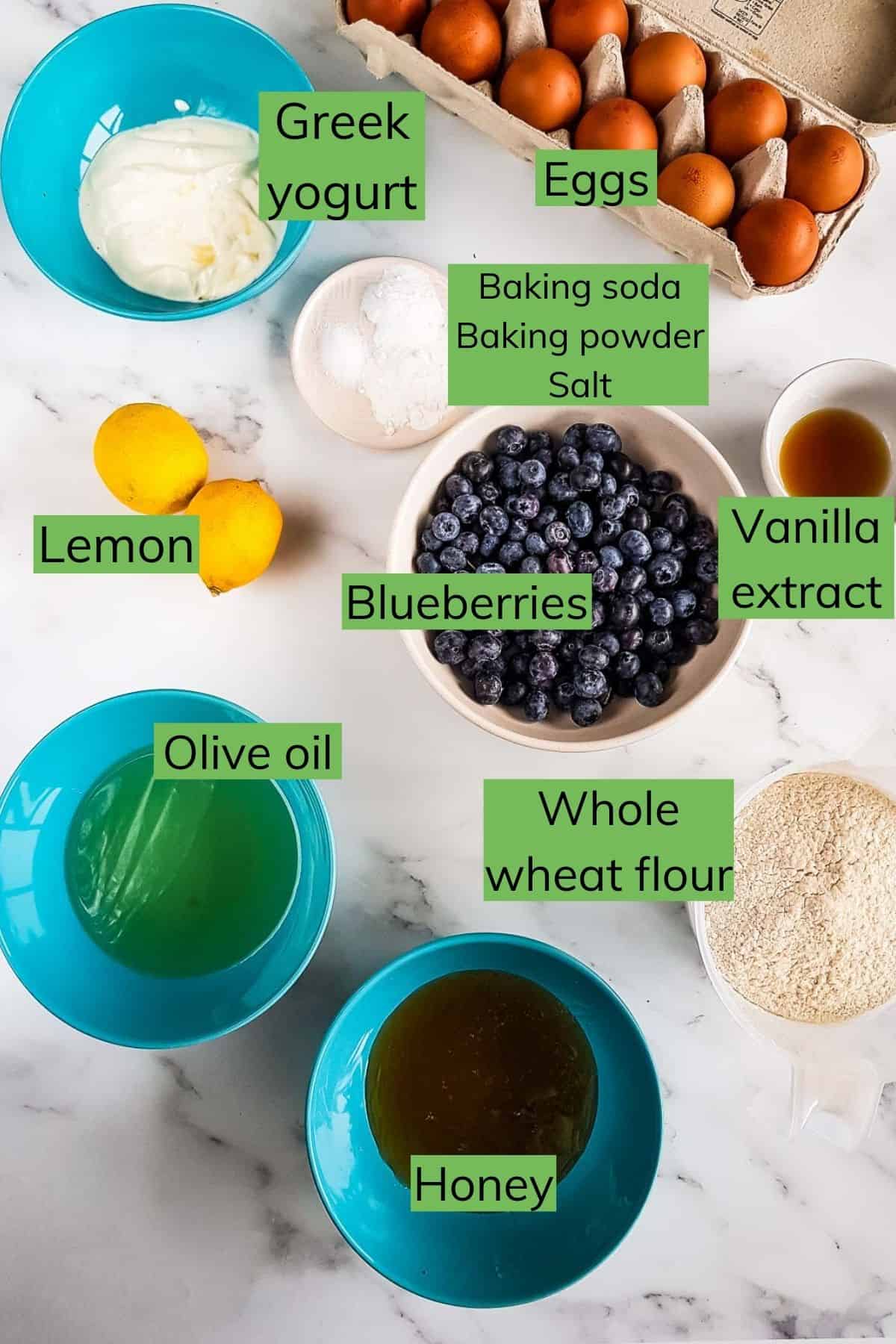 Ingredients for making lemon blueberry muffins on a table.