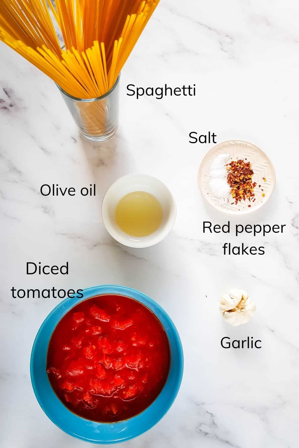 Ingredients for pasta arrabbiata laid out on a table.