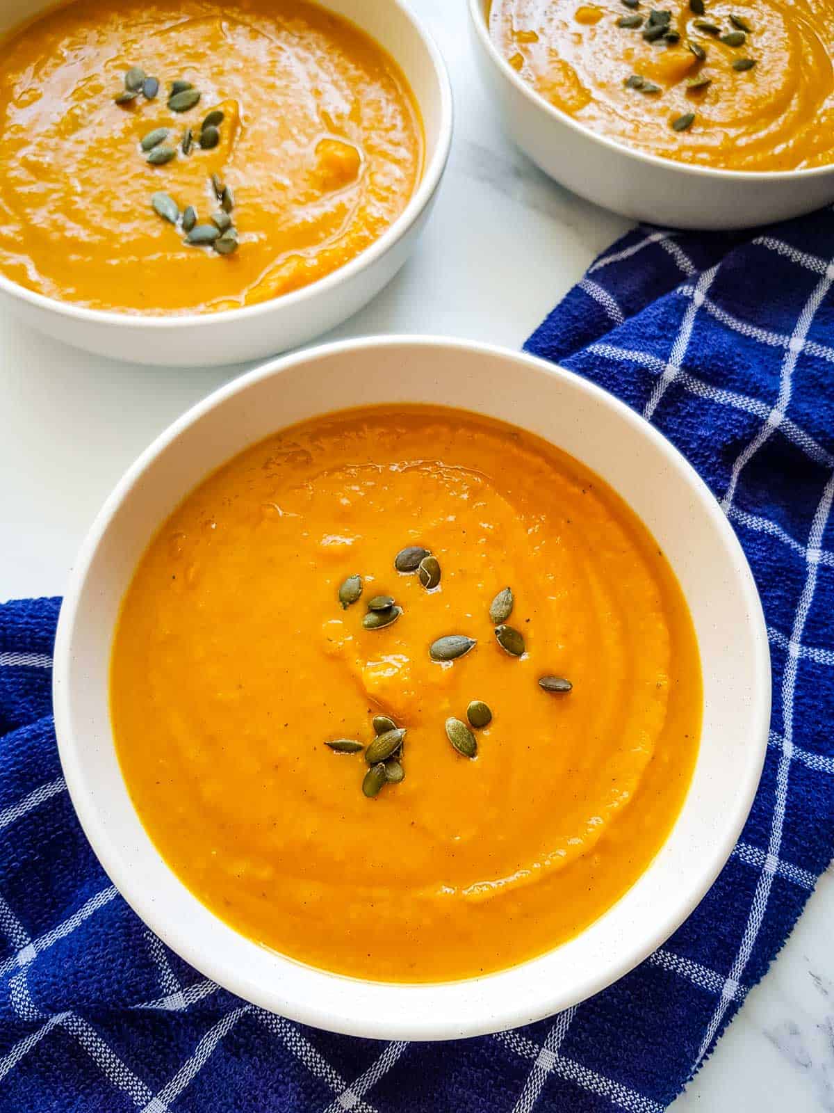 Sweet potato and pumpkin soup in bowls.