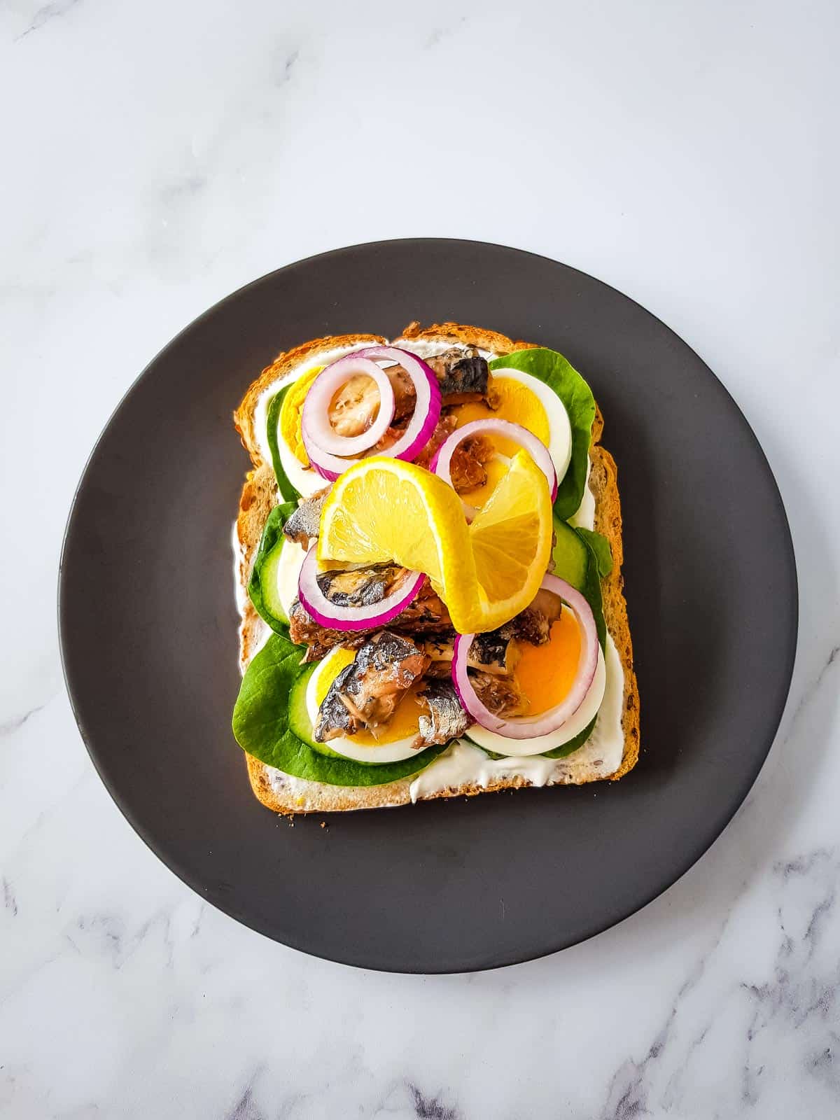 Scandinavian sardine sandwich on a plate.