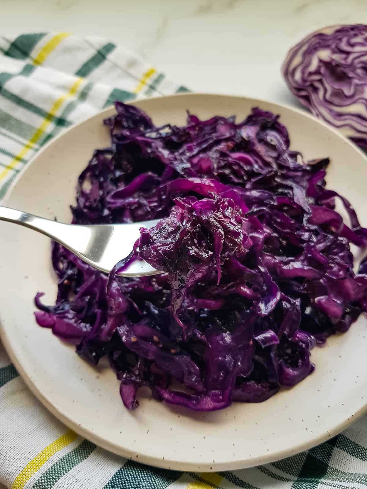 Sauteed red cabbage on a plate with a fork.