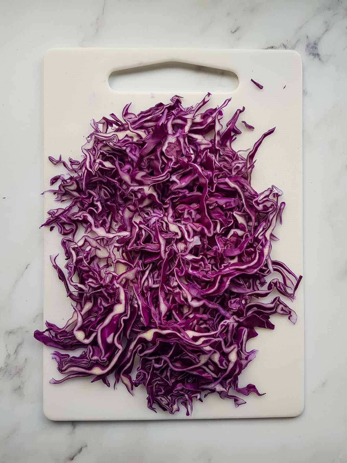 Sliced red cabbage on a chopping board.