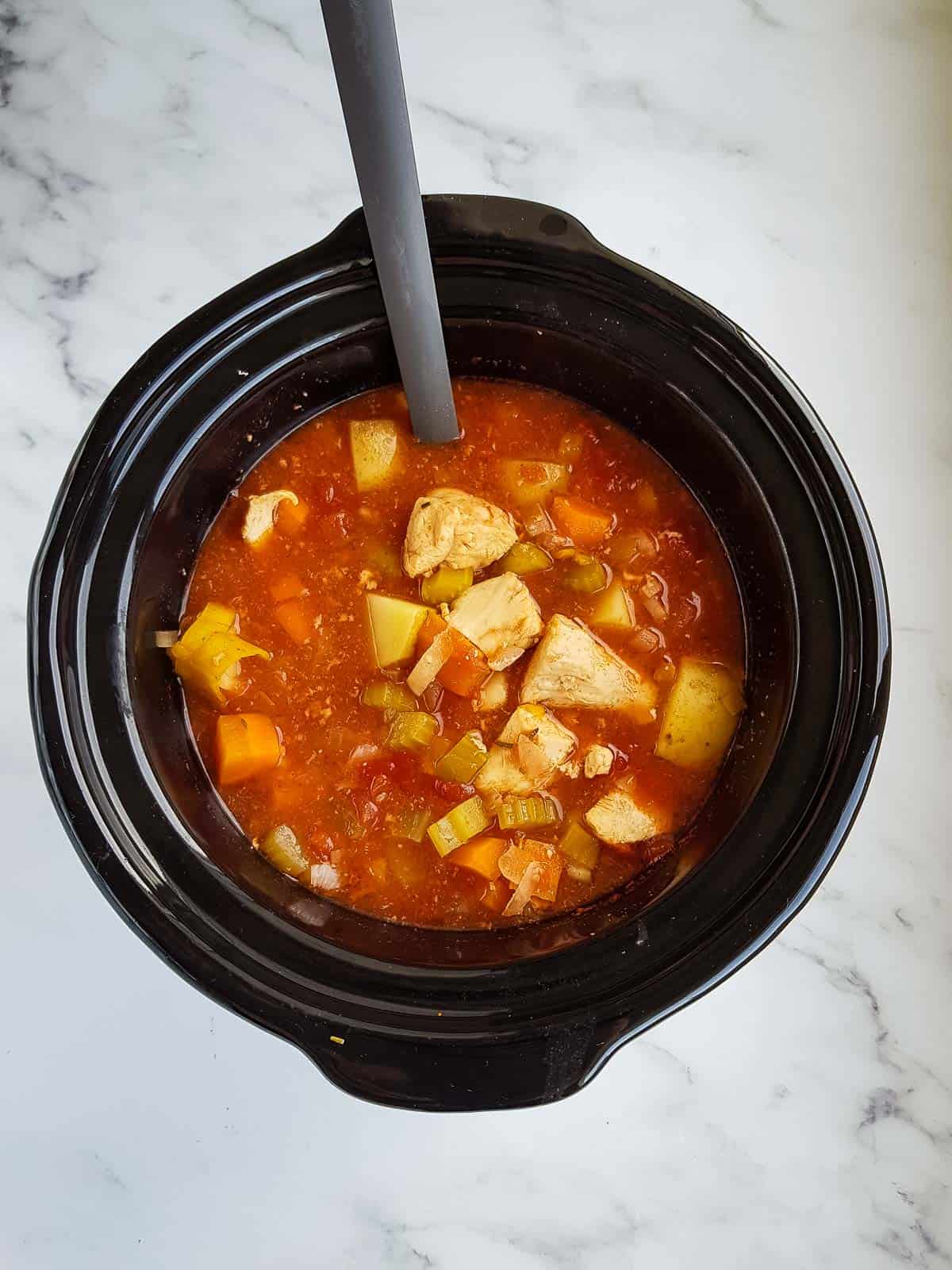 Cooked chicken stew in a slow cooker.