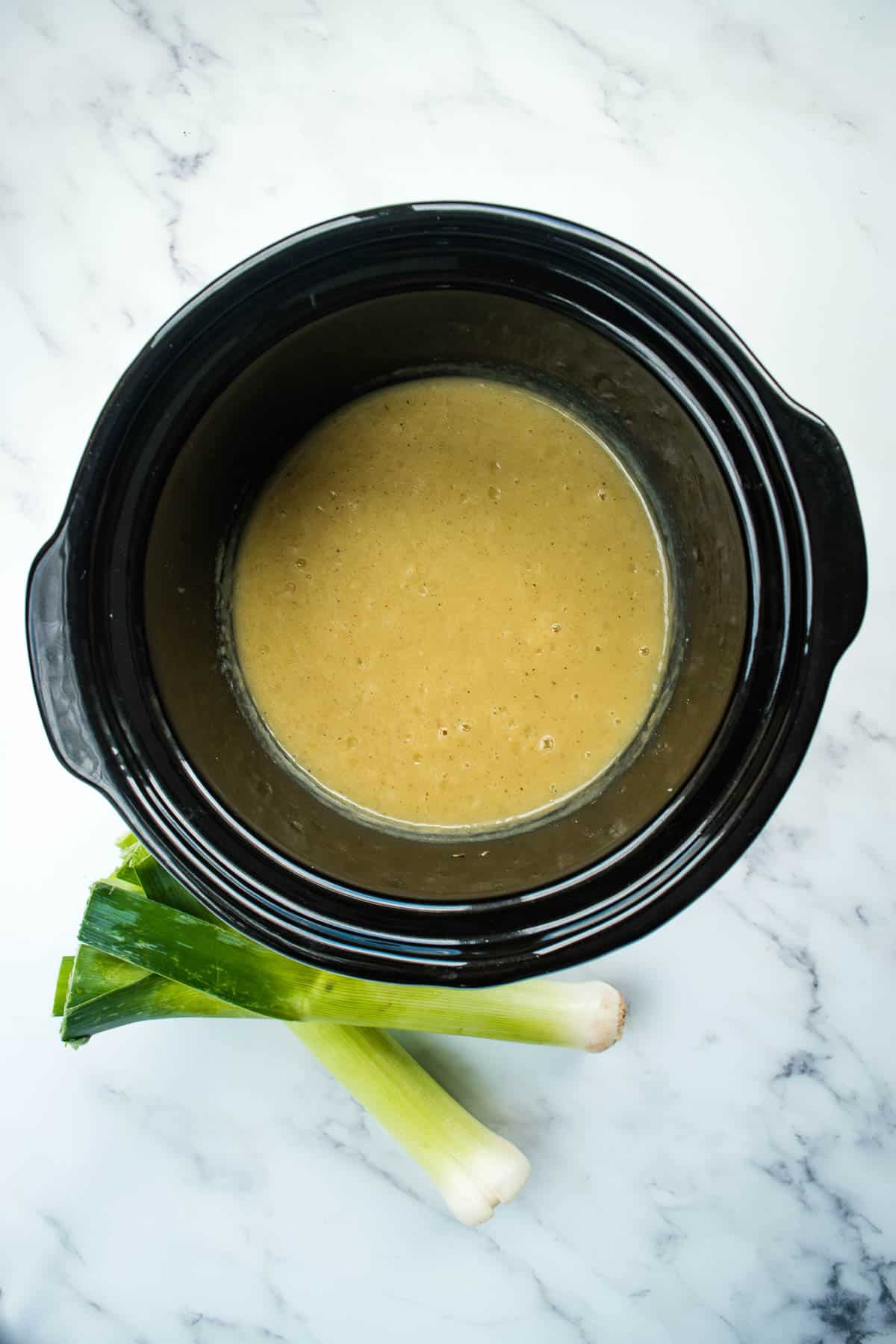 Creamy leek and potato soup in a crockpot.