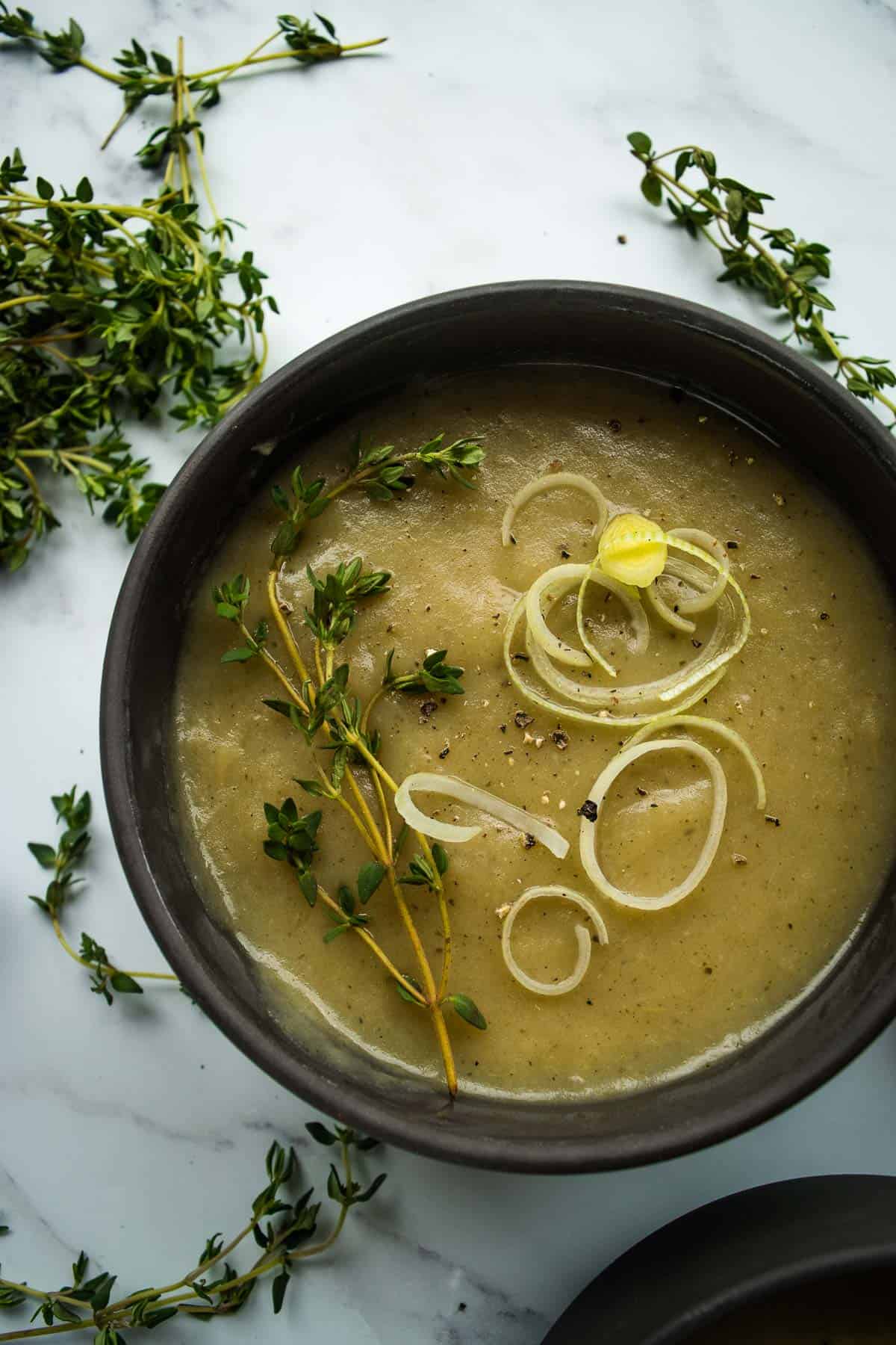 Slow cooker leek and potato soup in a bowl.