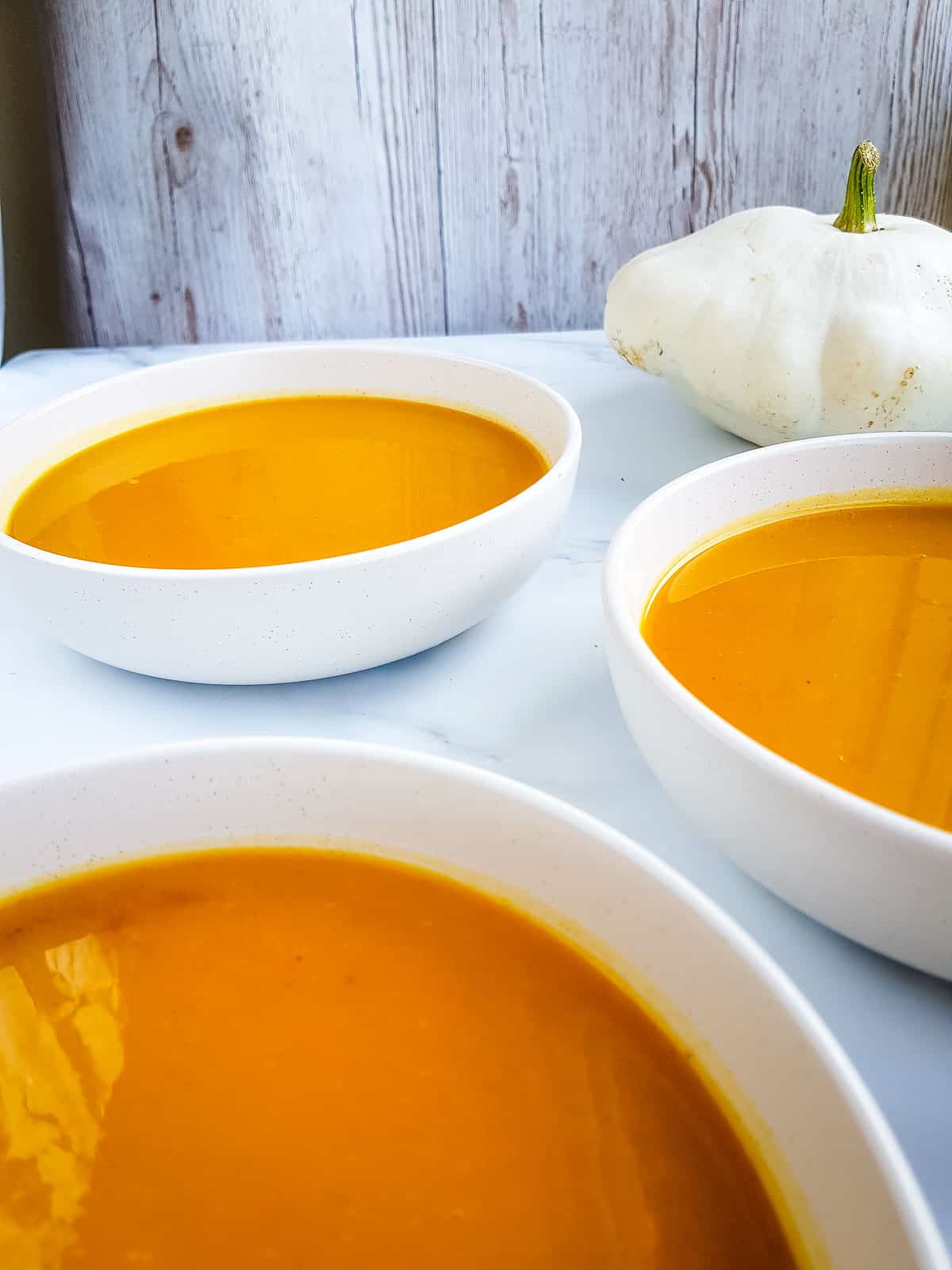 Bowls of slow cooked pumpkin soup.