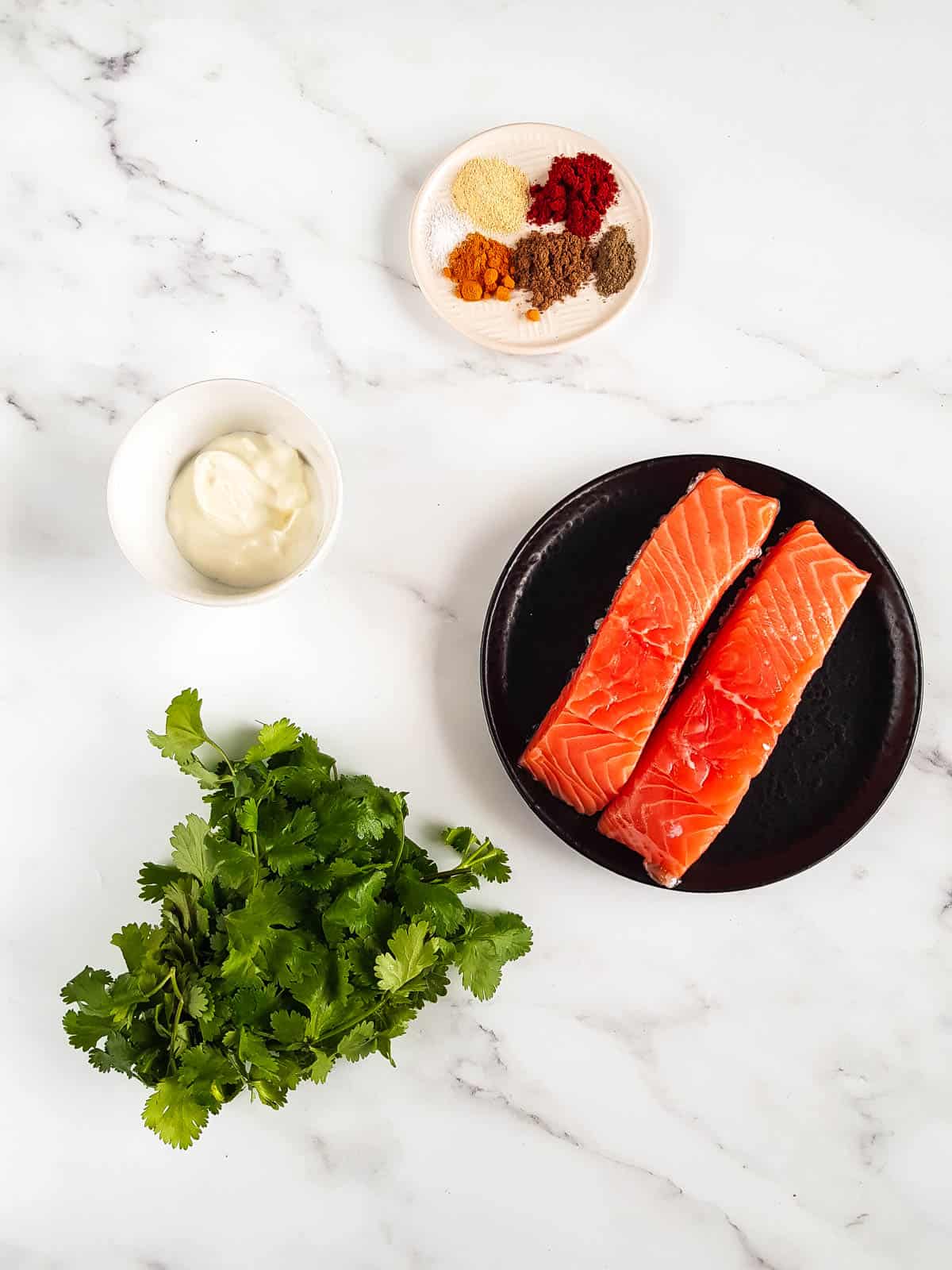 Ingredients for tandoori salmon laid out on a table.