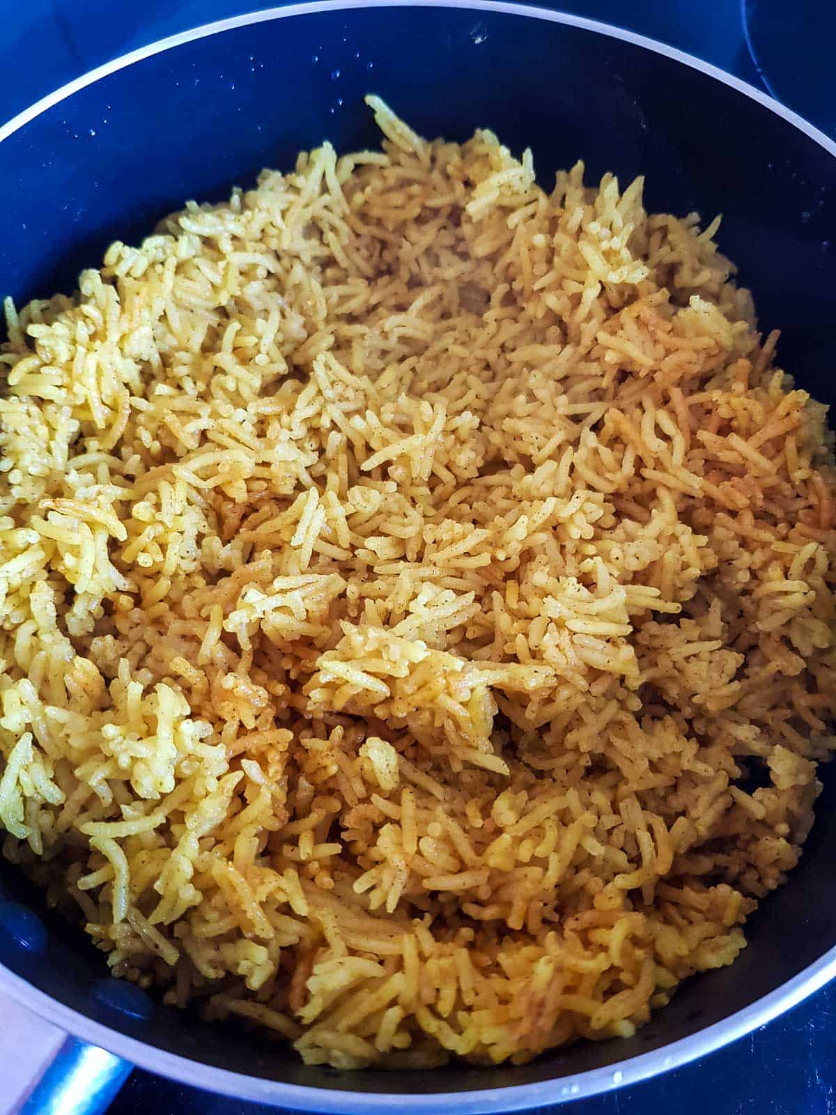 Cooked turmeric rice in a pot.