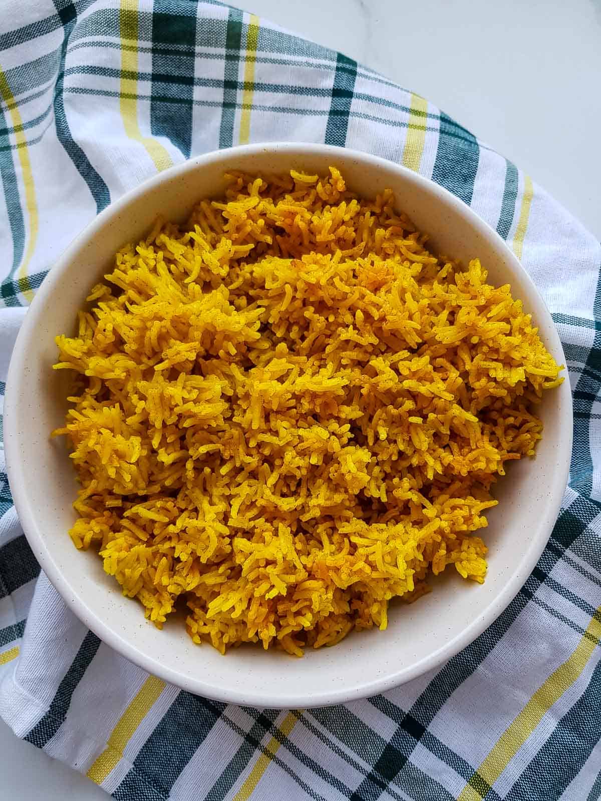 Cooked turmeric rice in a bowl.