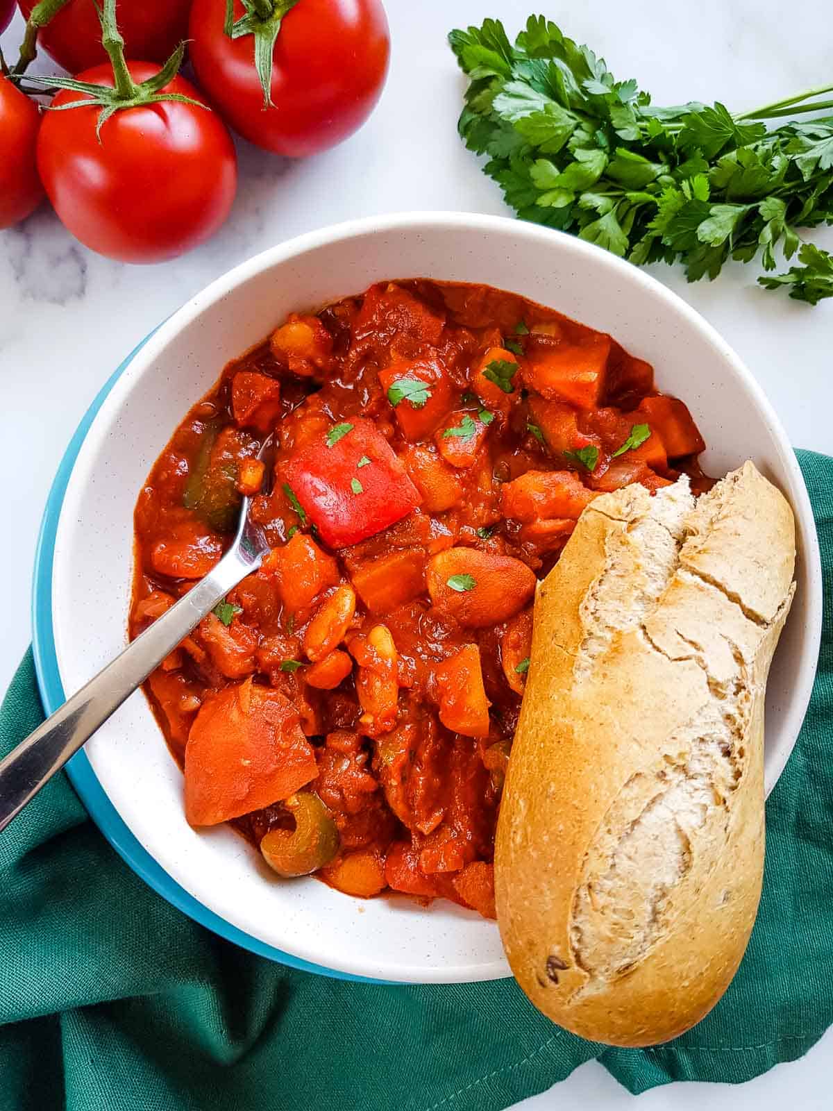 Goulash with peppers, potatoes and carrots with a baguette on the side.