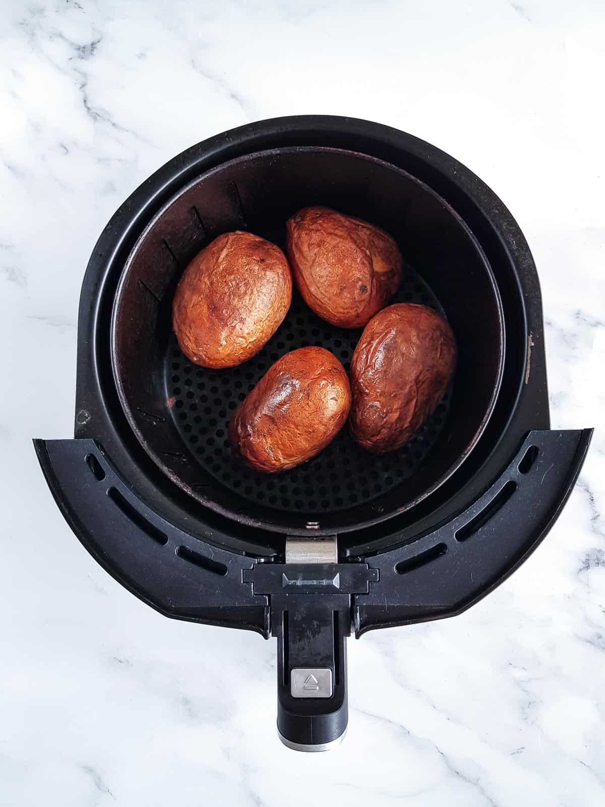 Baked potatoes in an air fryer.