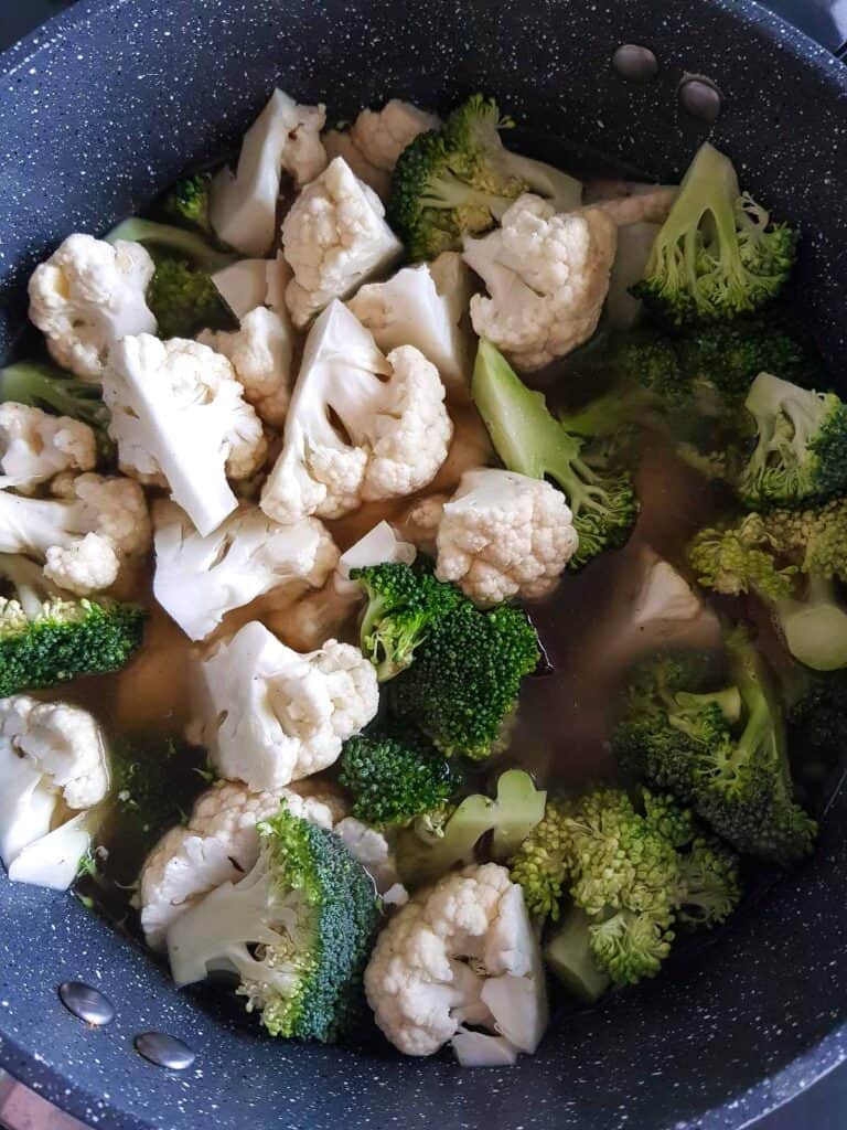 Broccoli and cauliflower in a pot.