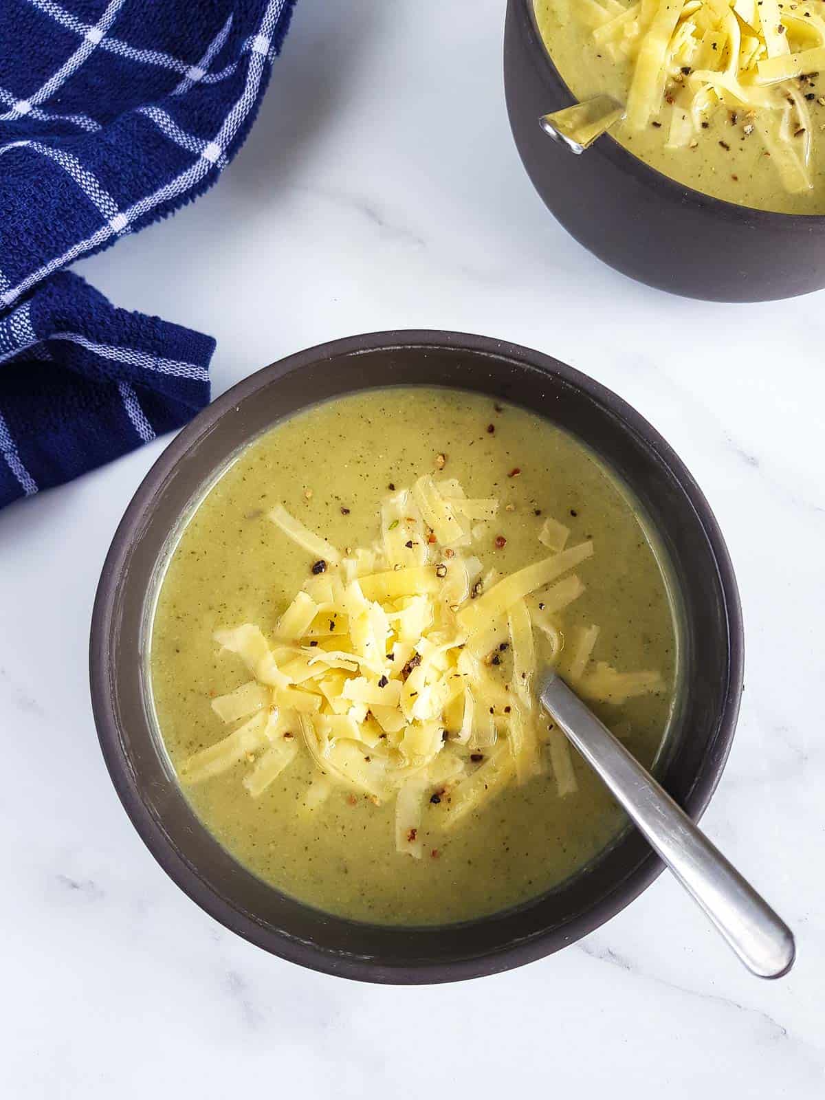 Cauliflower and broccoli soup topped with cheddar.