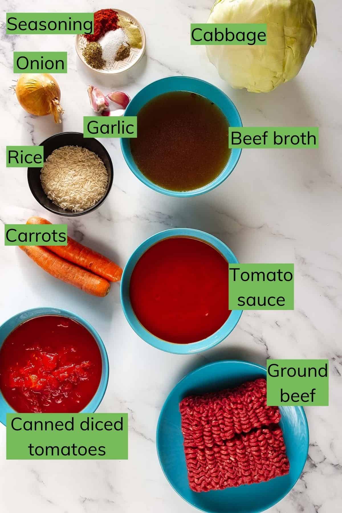 Ingredients needed to make cabbage roll soup laid out on a table.