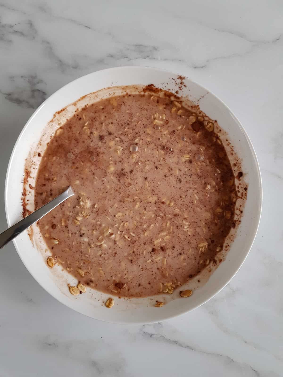 Making chocolate oats in a bowl.