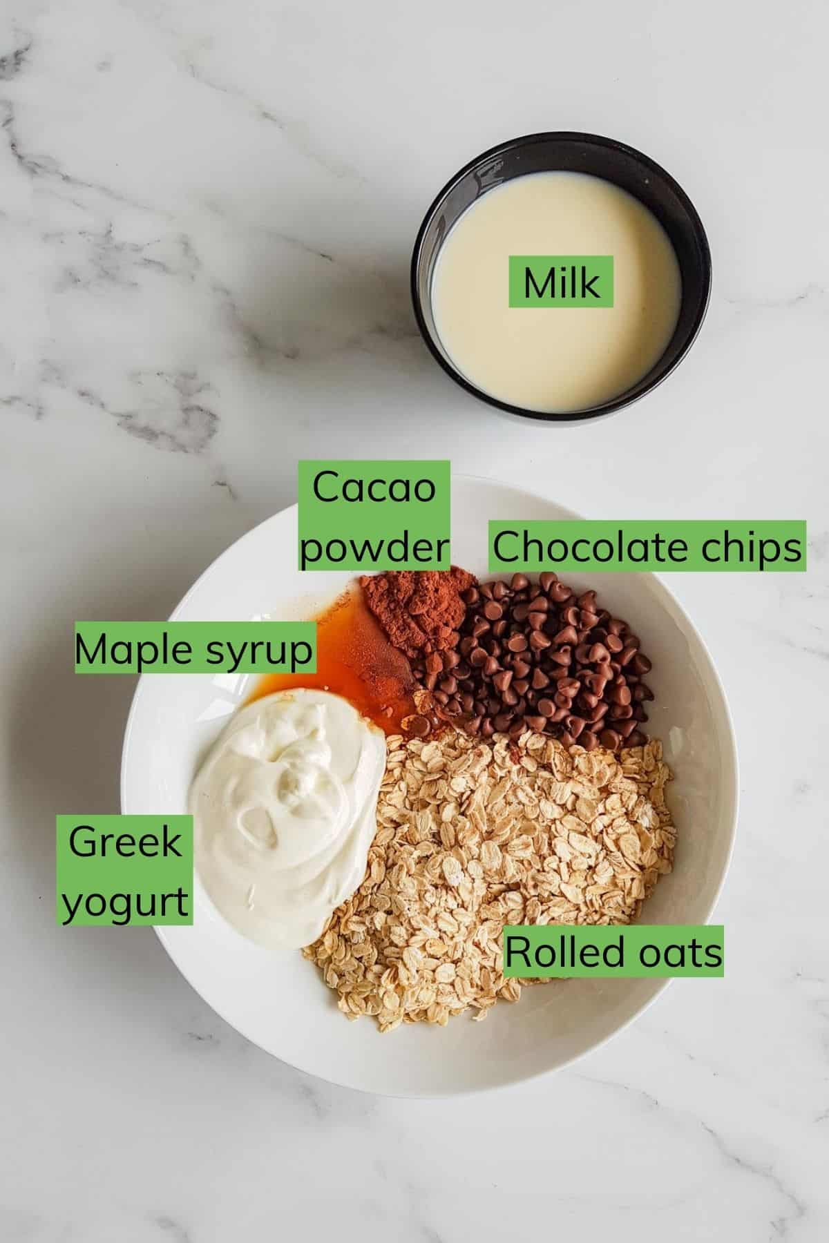 The ingredients required to make chocolate overnight oats laid out on a table.