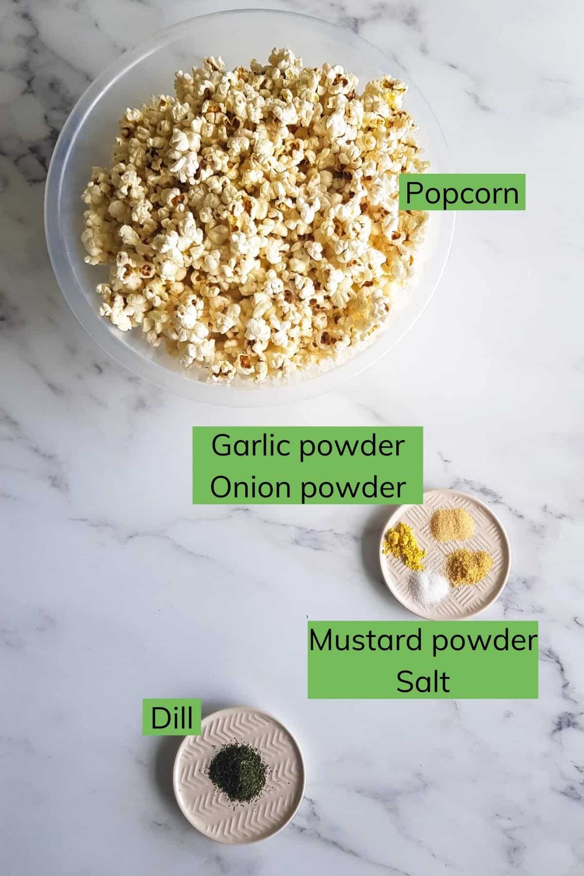 The ingredients for dill pickle popcorn laid out on a table.