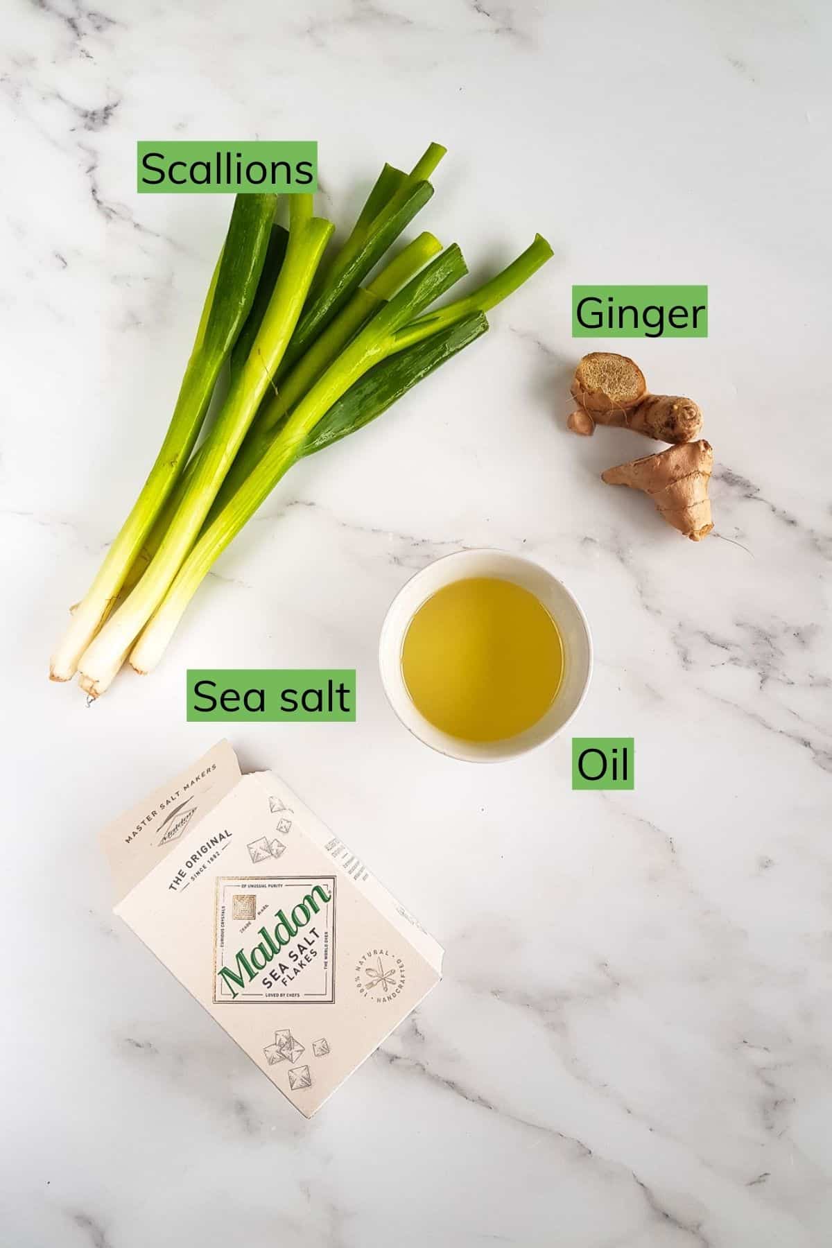 Ingredients needed to make ginger scallion sauce on a table.