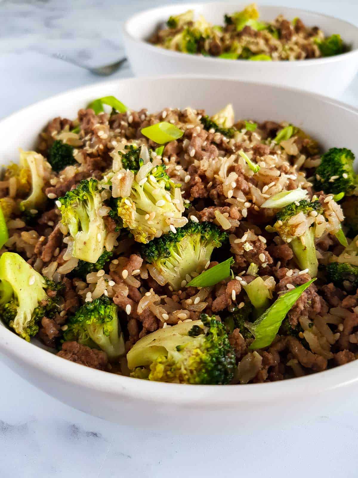 Close up of a bowl of ground beef and broccoli stir fry.