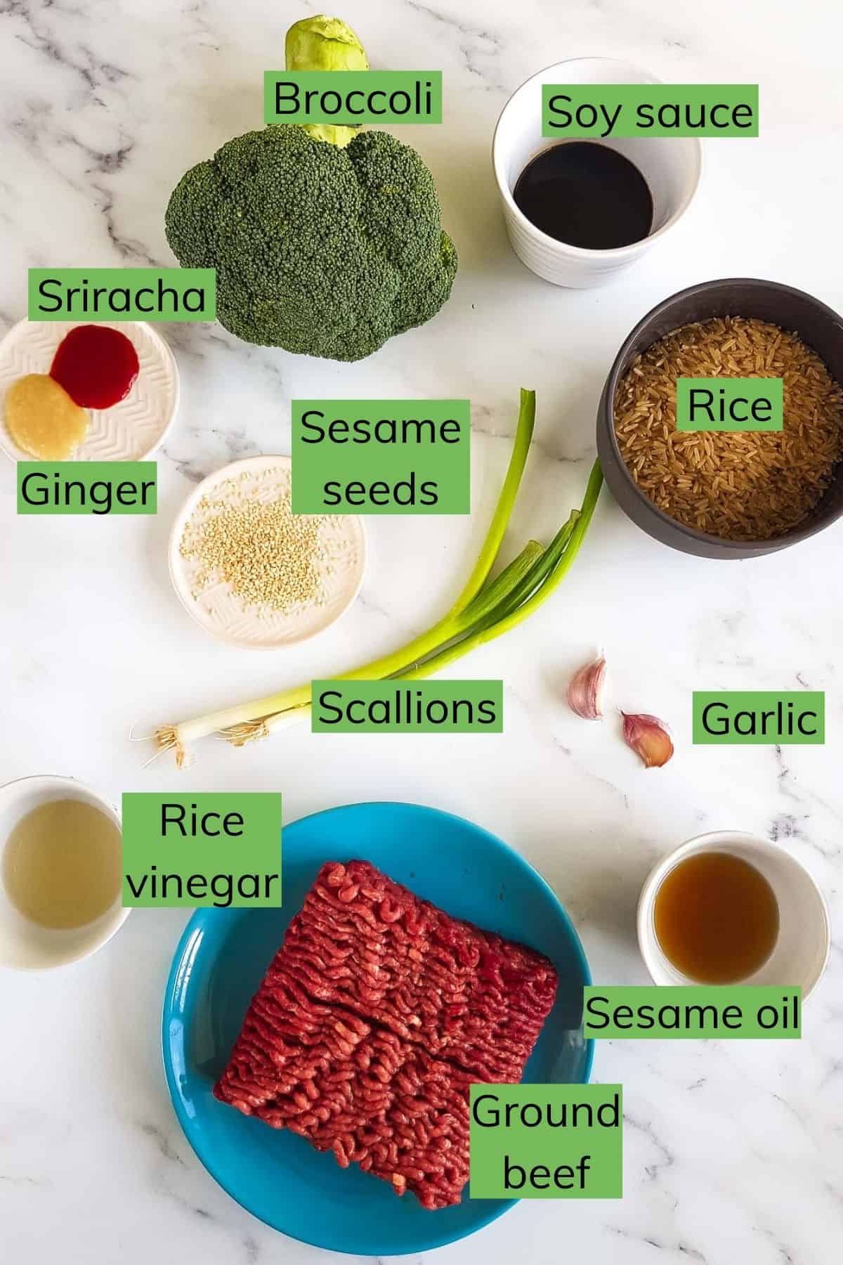 The ingredients needed to make ground beef and broccoli laid out on a table.