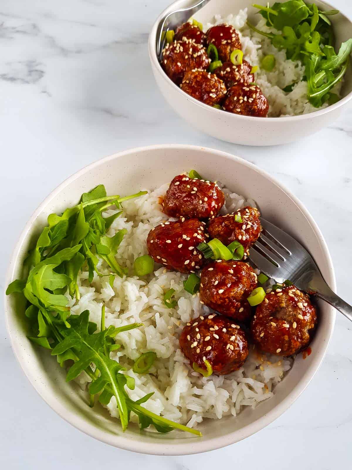 Two bowls of spicy turkey meatballs and rice.