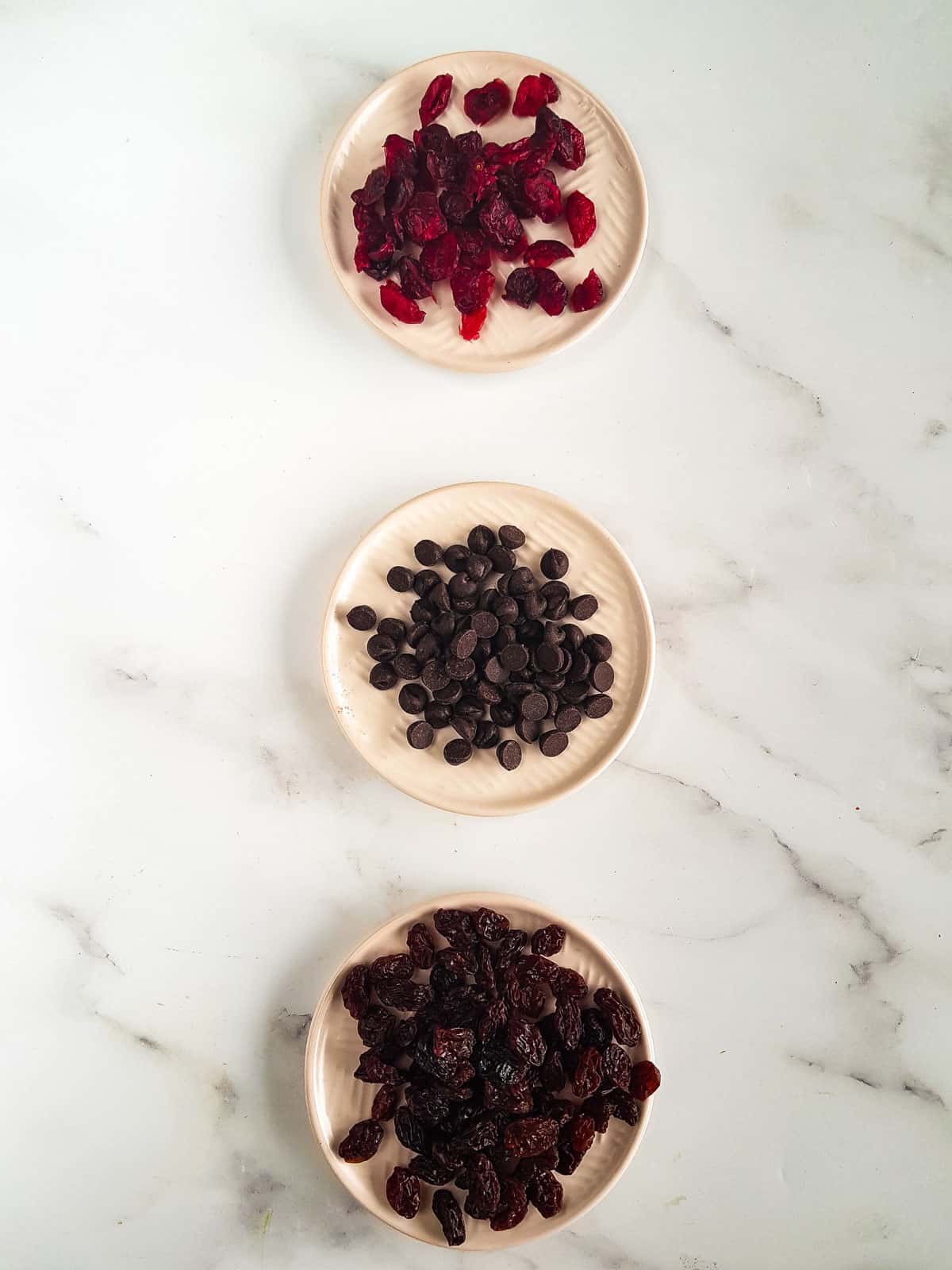 Bowls of cranberries, chocolate chips and raisins.