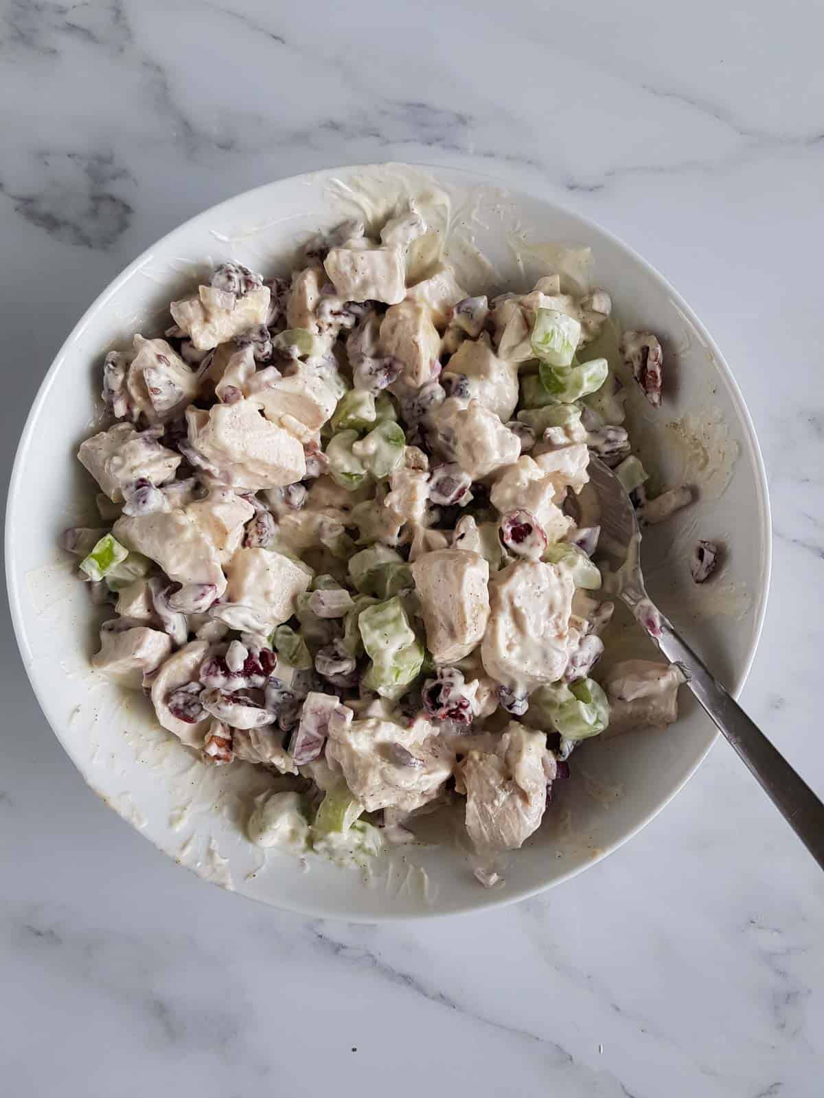 Mixing the salad ingredients in a bowl.