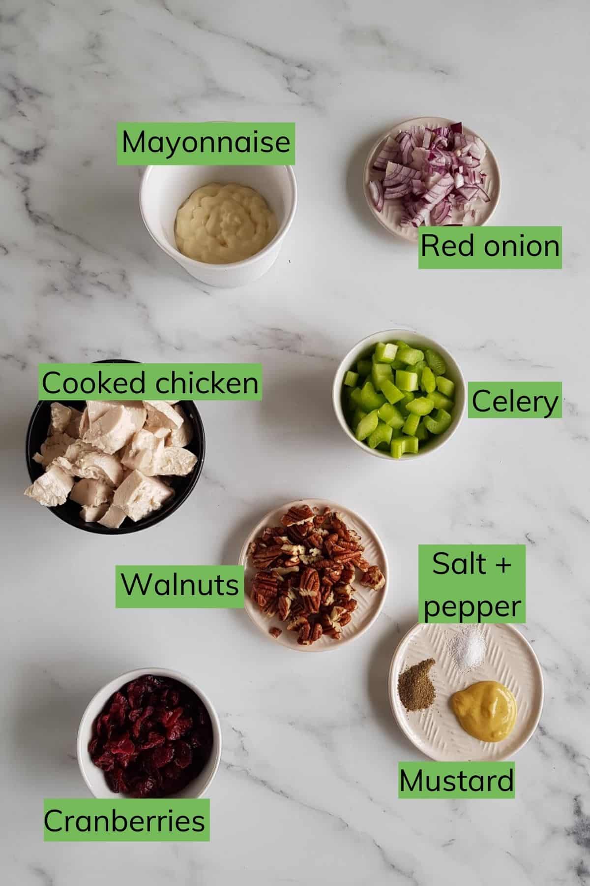 Ingredients for cranberry chicken salad laid out on a table.