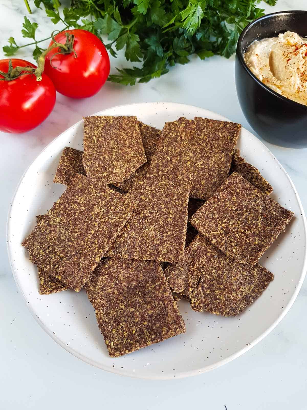 A plate full of flaxseed crackers.