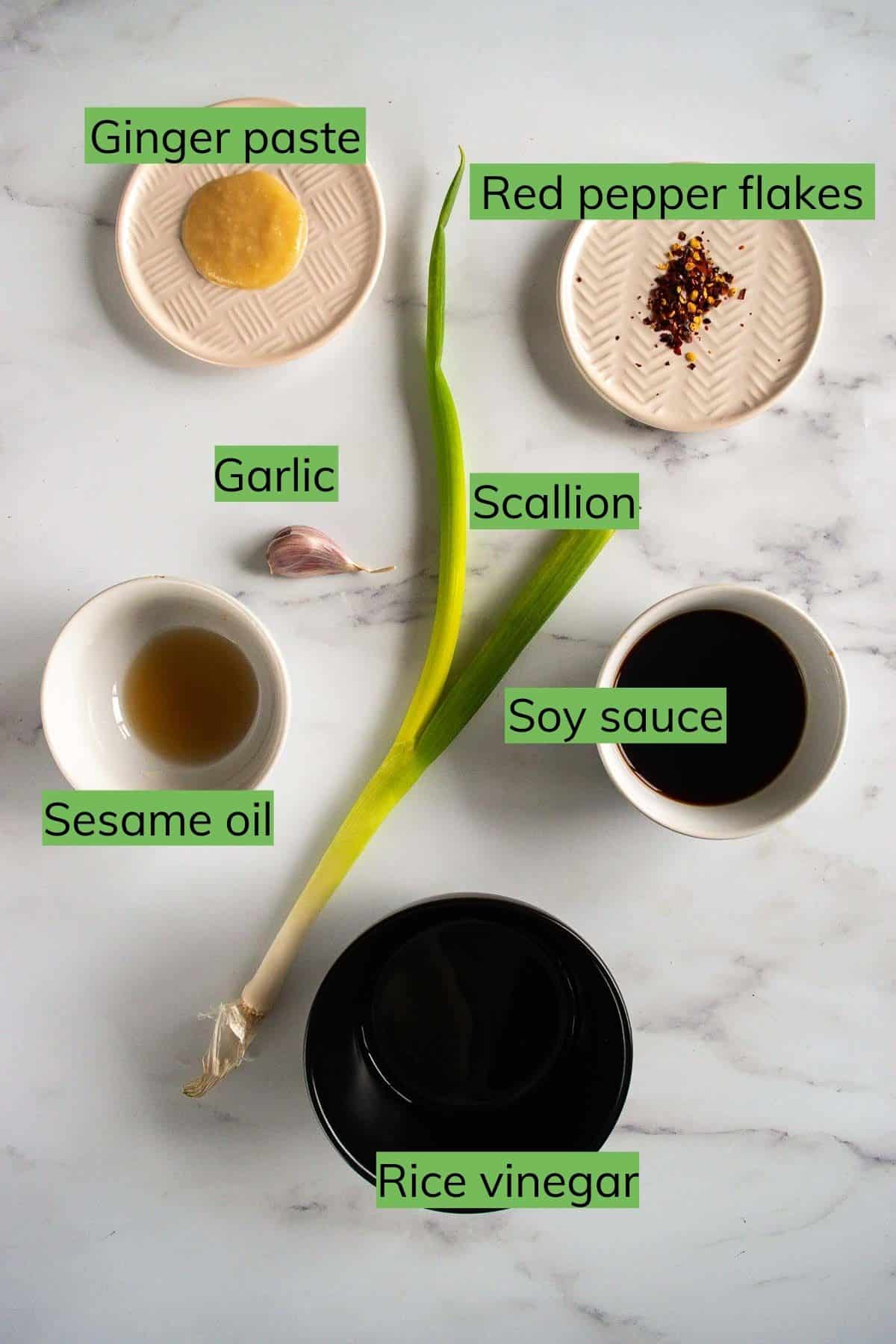 Ingredients required to make gyoza sauce laid out on a table.