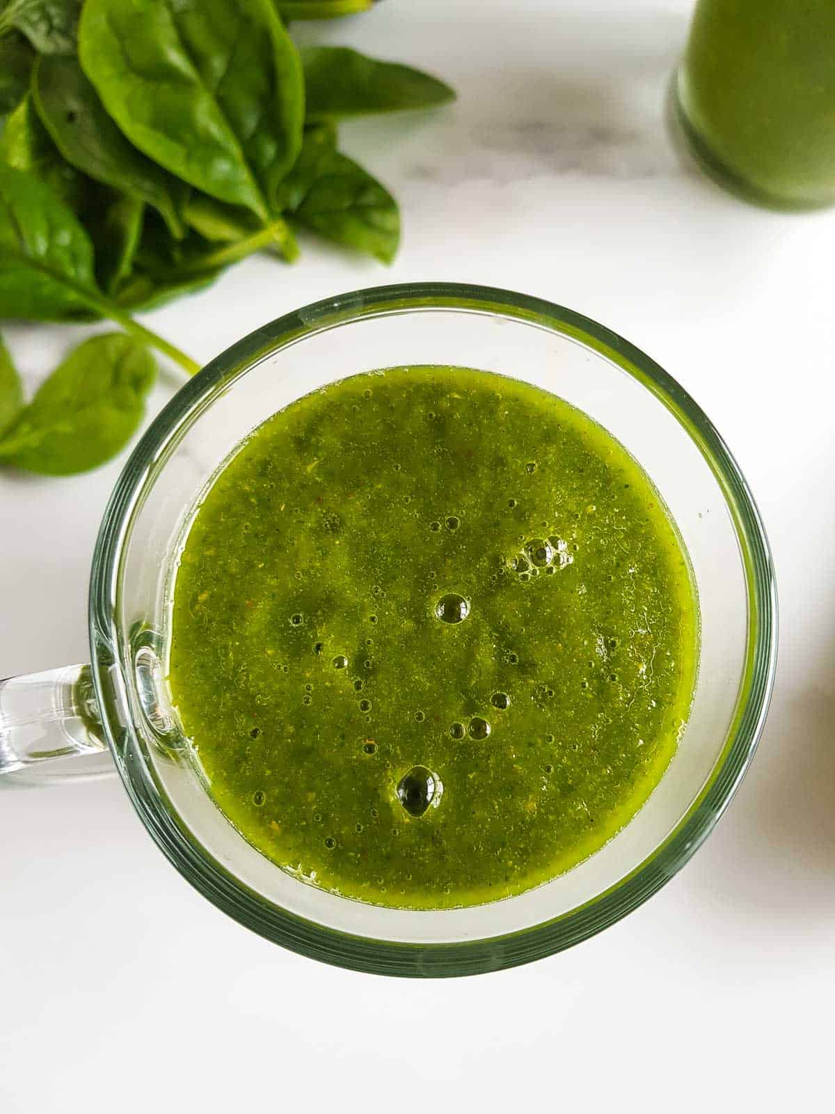 Close up of a glass of pear smoothie.