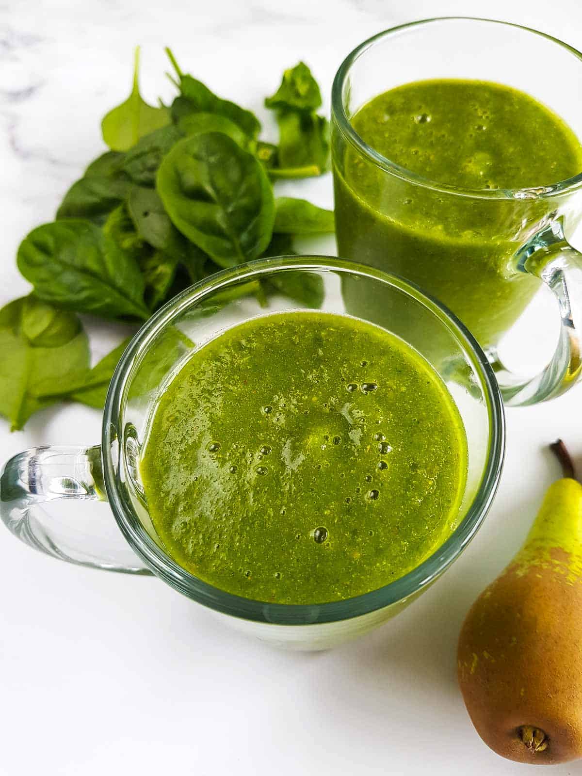 Two glasses of green pear smoothie.