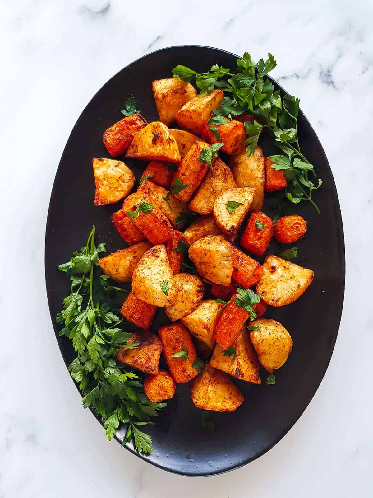 Roasted carrots and potatoes on a serving platter.