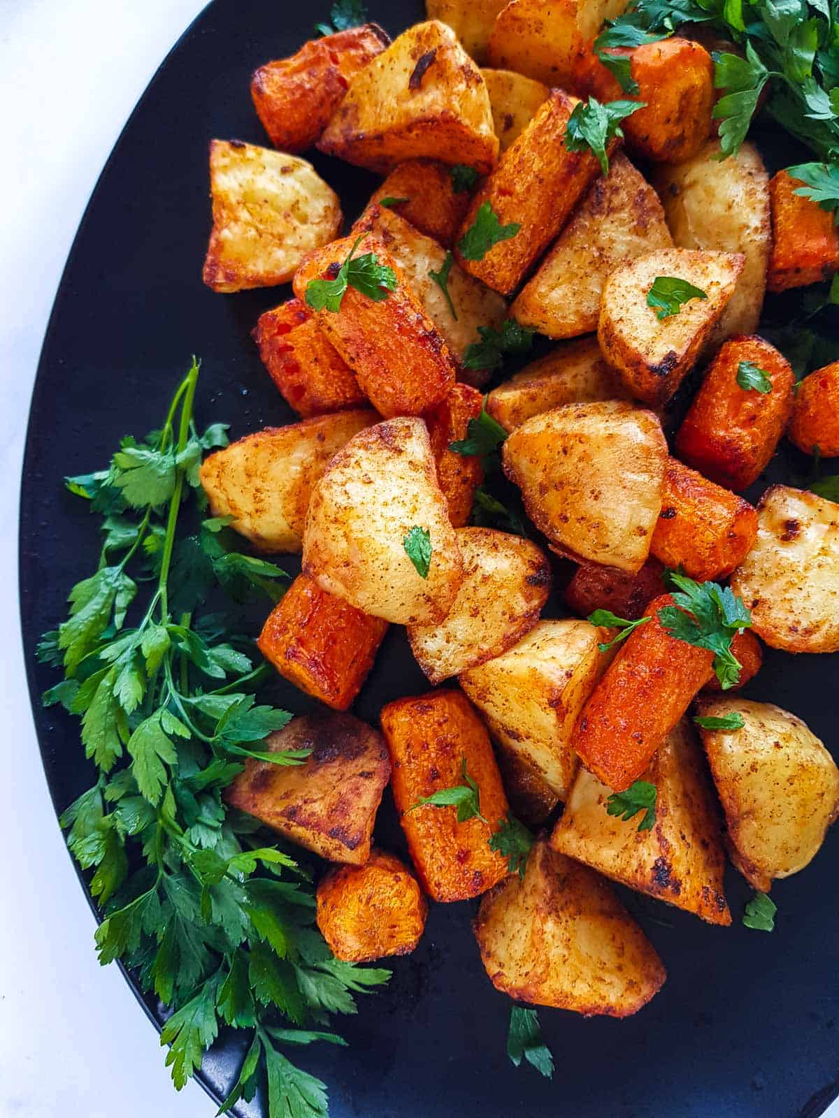 A close up of roasted potatoes and carrots.