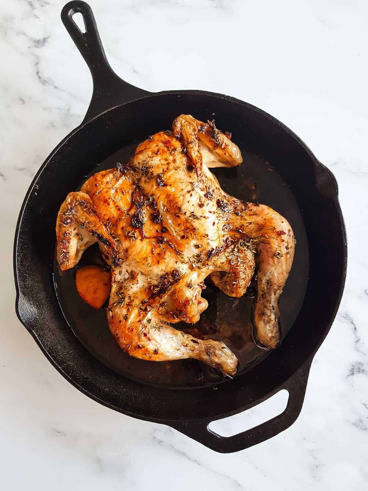 Roast butterflied chicken in a cast iron skillet.