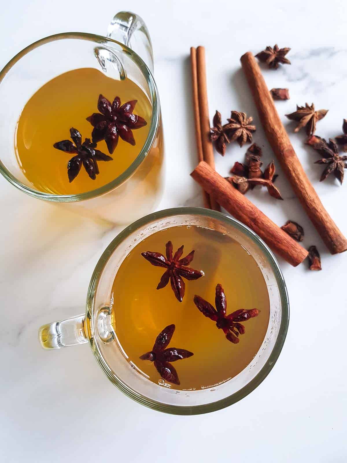 Two glasses of tea with star anise.