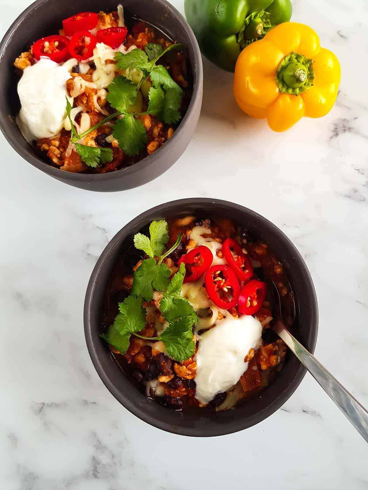 Overhead view of bowls filled with chili.