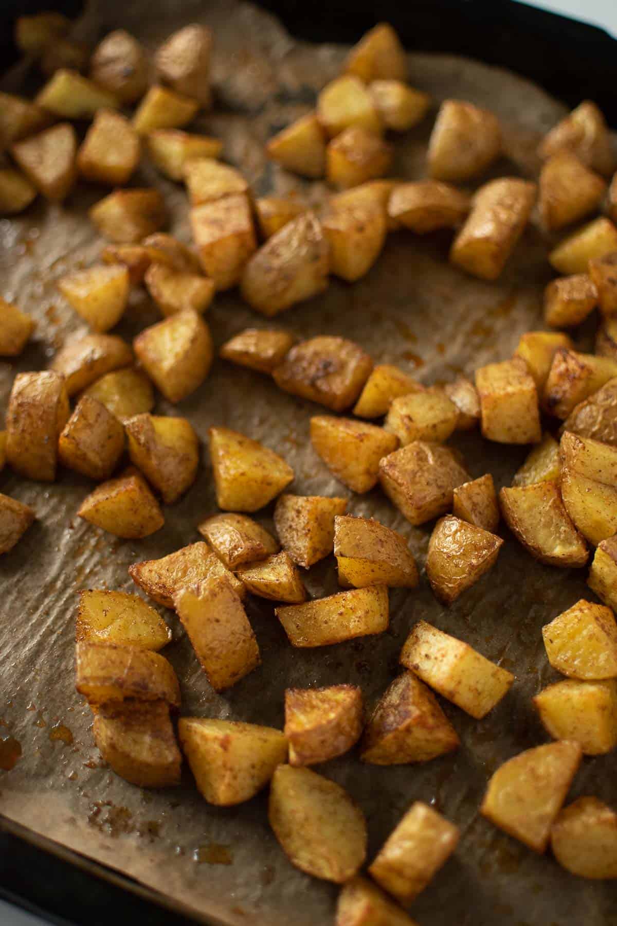 A baking pan with Mexican roast potato chunks.