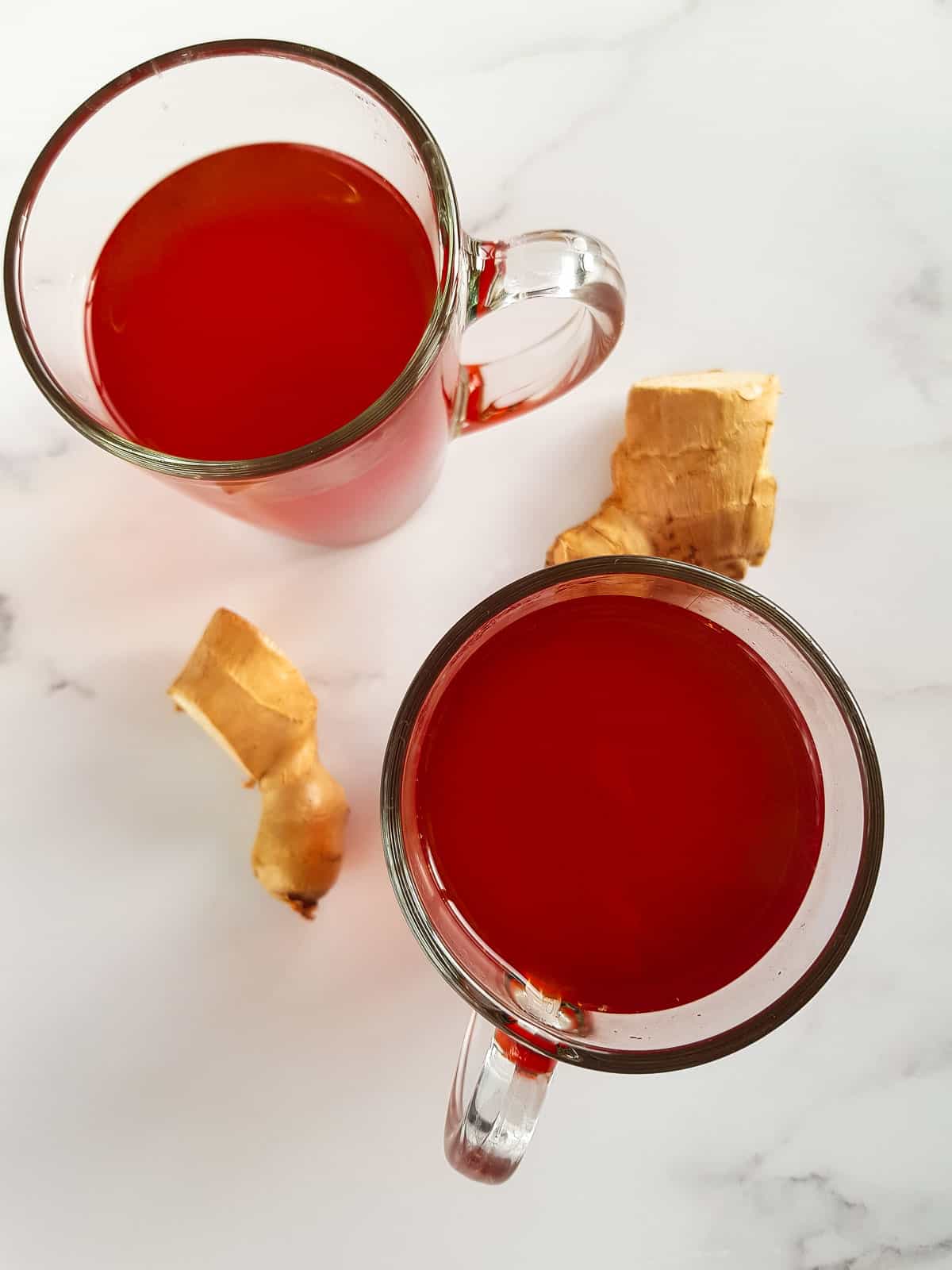 Cups of turmeric ginger tea on a table.