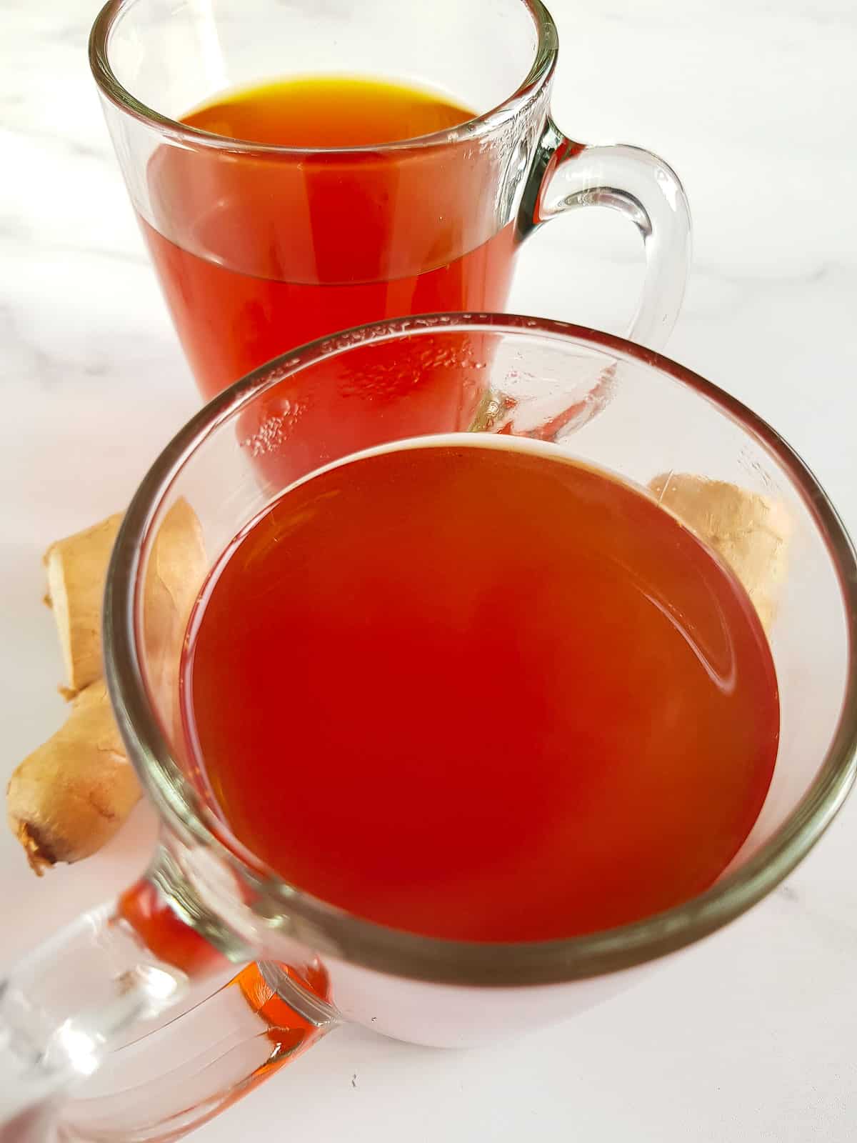 Ginger and turmeric tea in cups.