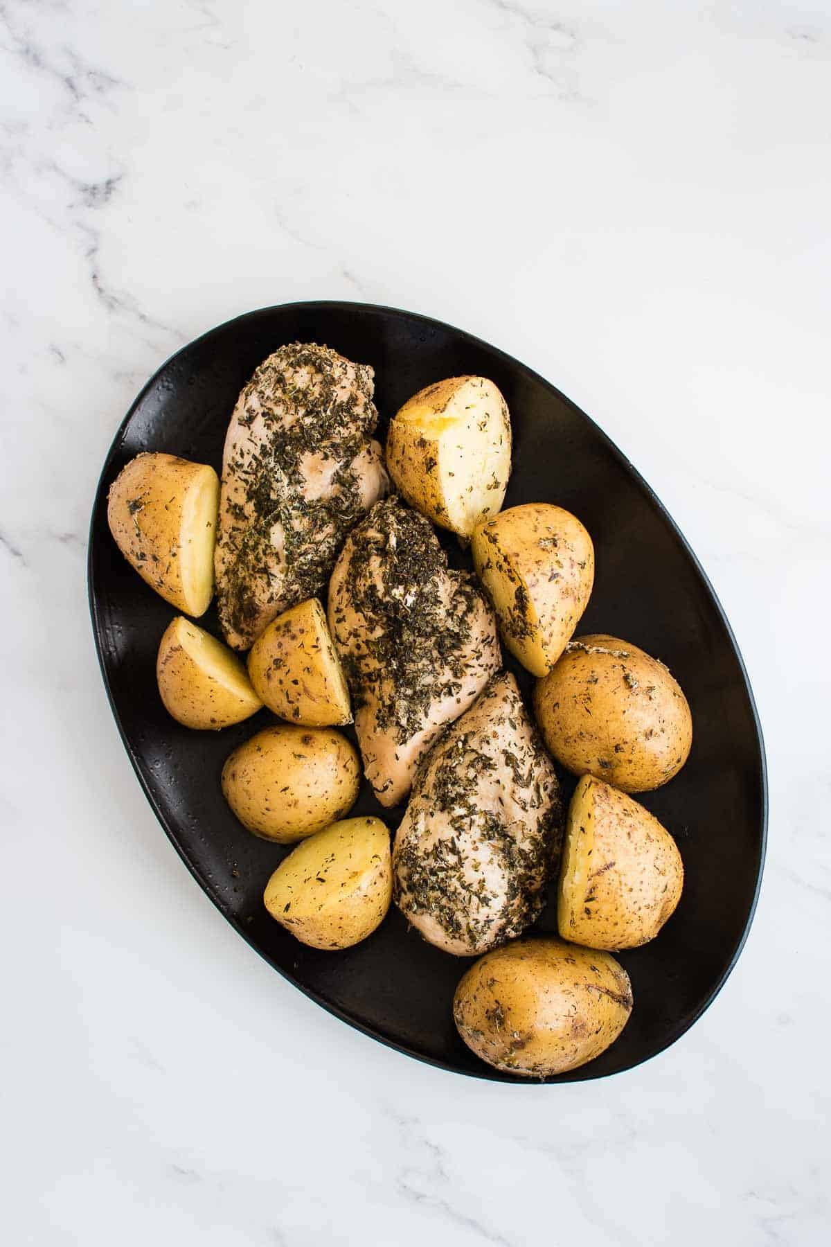 Chicken and potatoes on a serving dish.