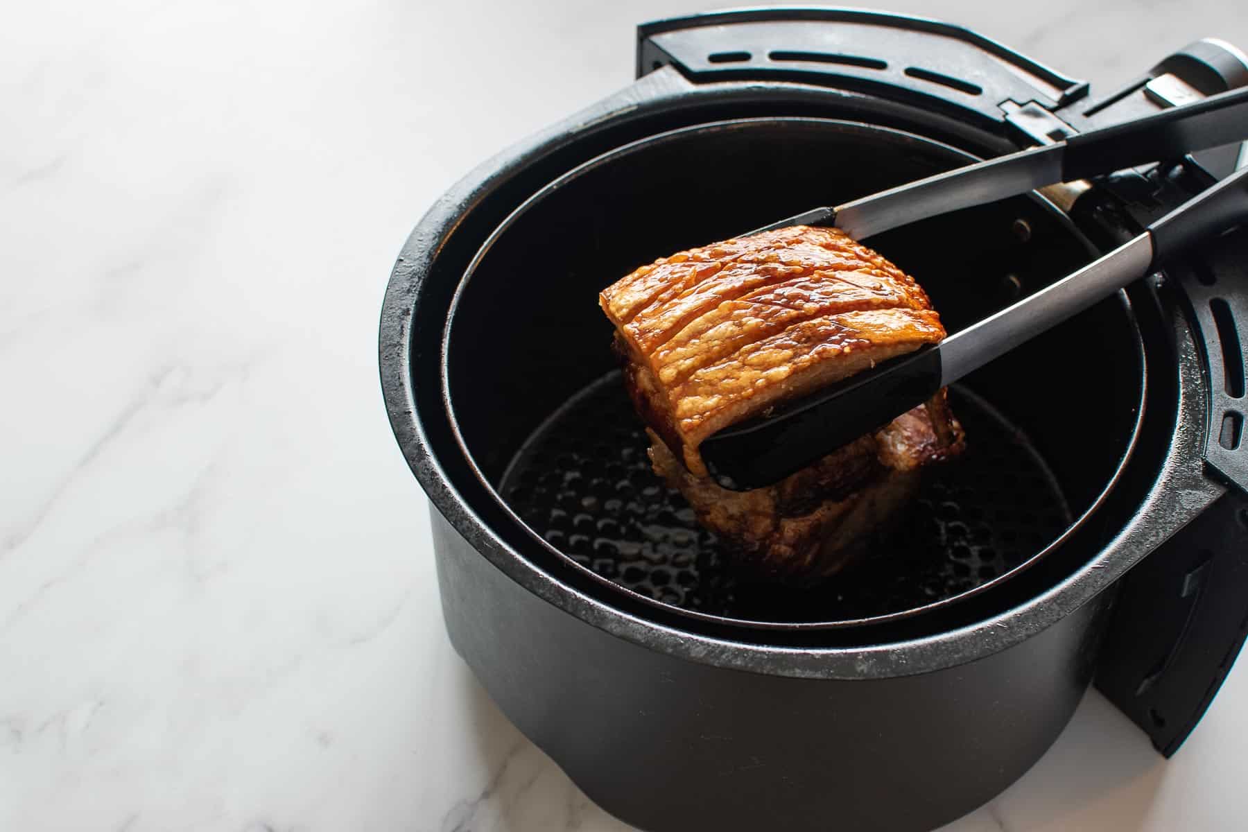 A pork roast in an air fryer.