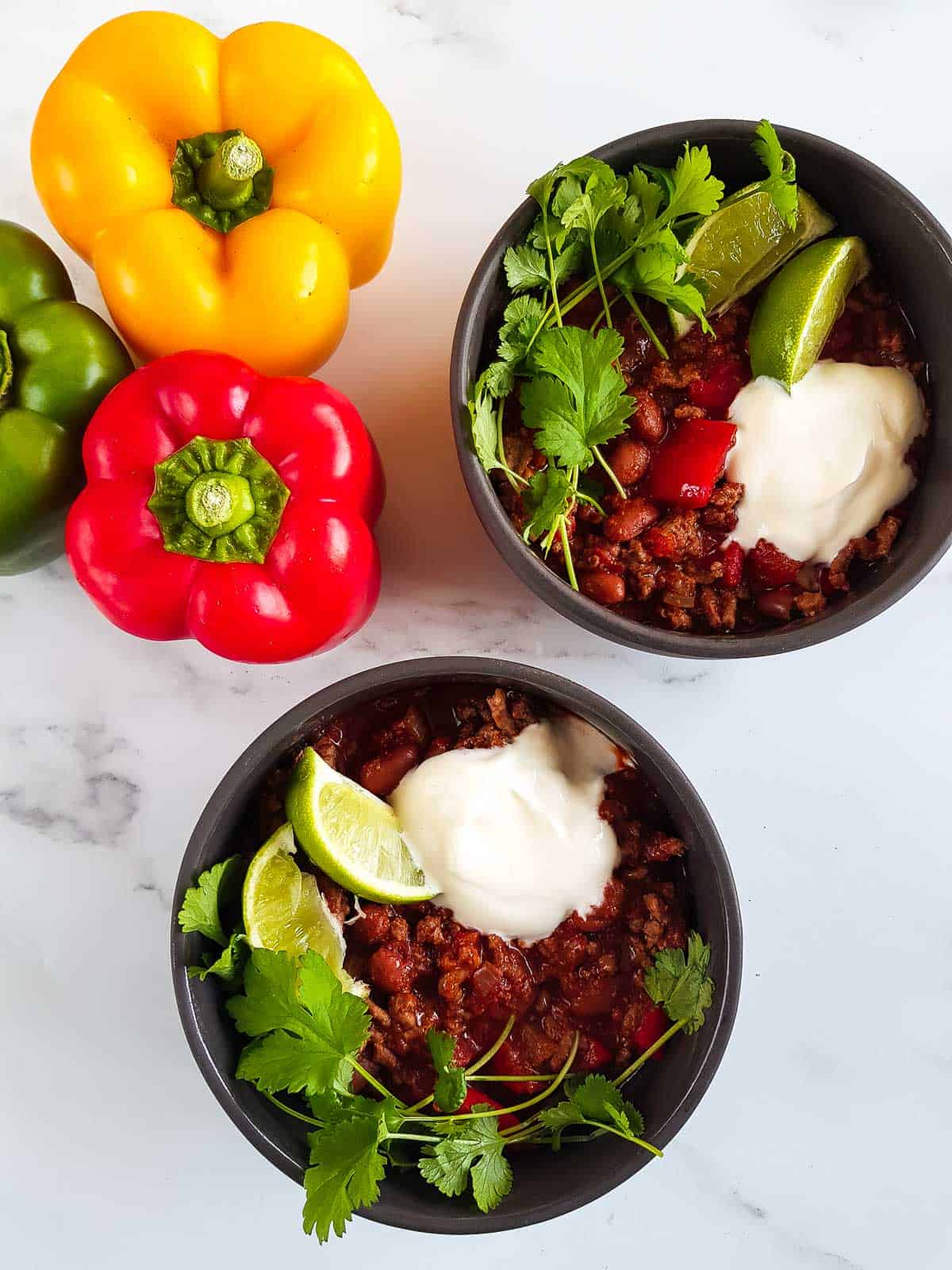 Two bowls of chilli con carne on a table.