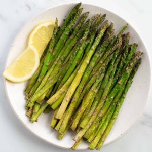 Air fried asparagus on a plate.