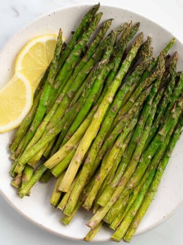 Air fried asparagus on a plate.