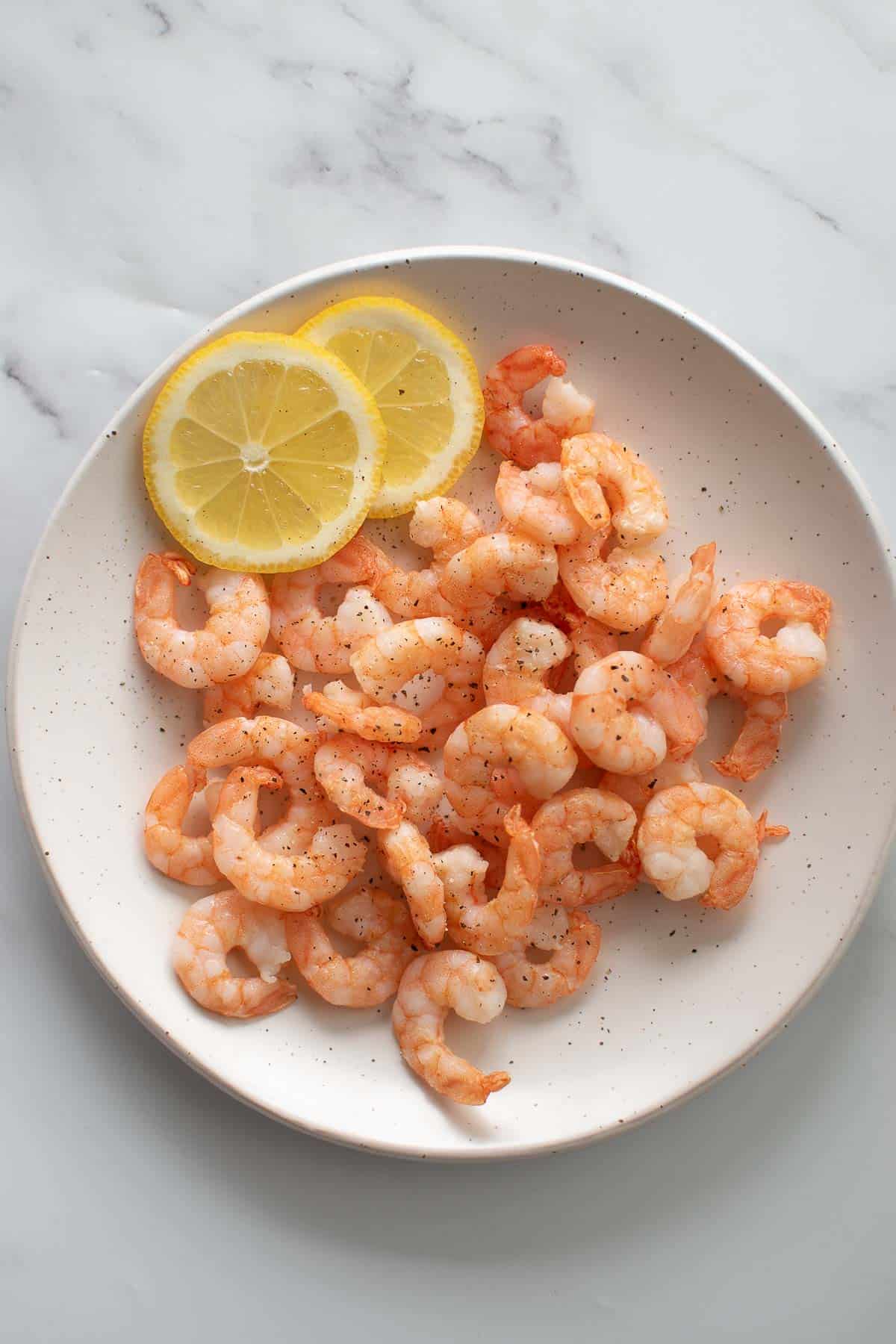 A plate with air fryer frozen shrimp.